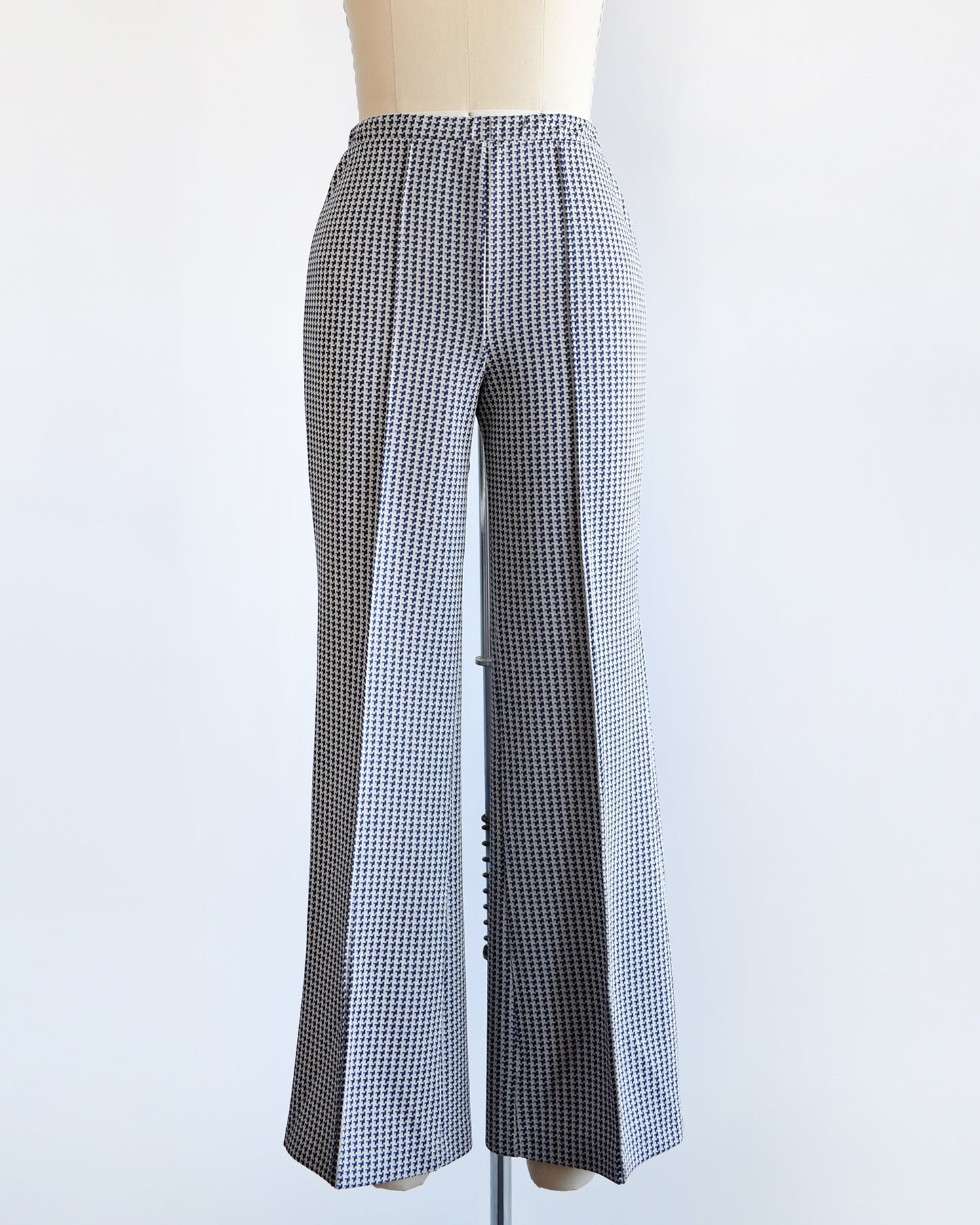 a pair of vintage 1970s wide leg pants with houndstooth print