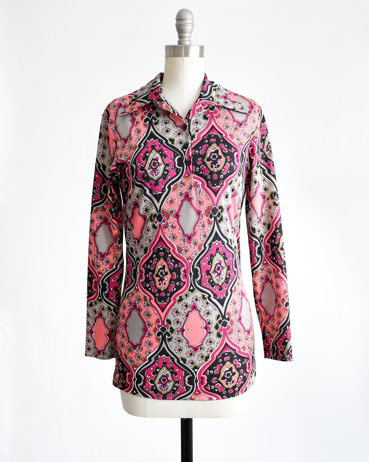 a vintage 1970s pink and black psychedelic floral blouse.