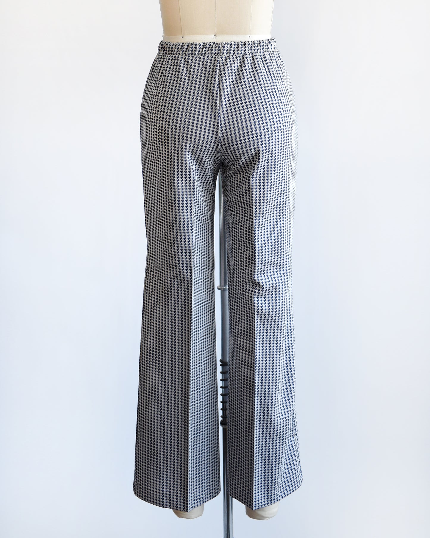 back view of a pair of vintage 1970s wide leg pants with houndstooth print