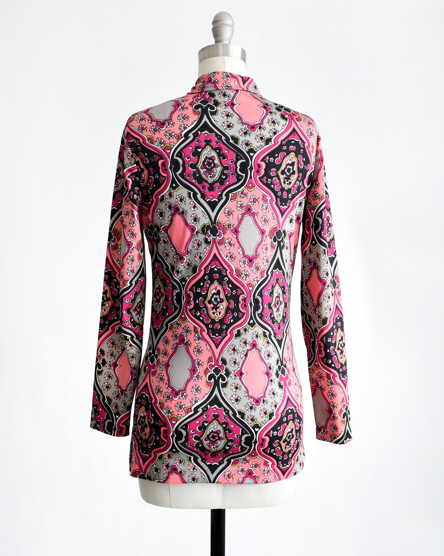 back view of a vintage 1970s pink and black psychedelic floral blouse.
