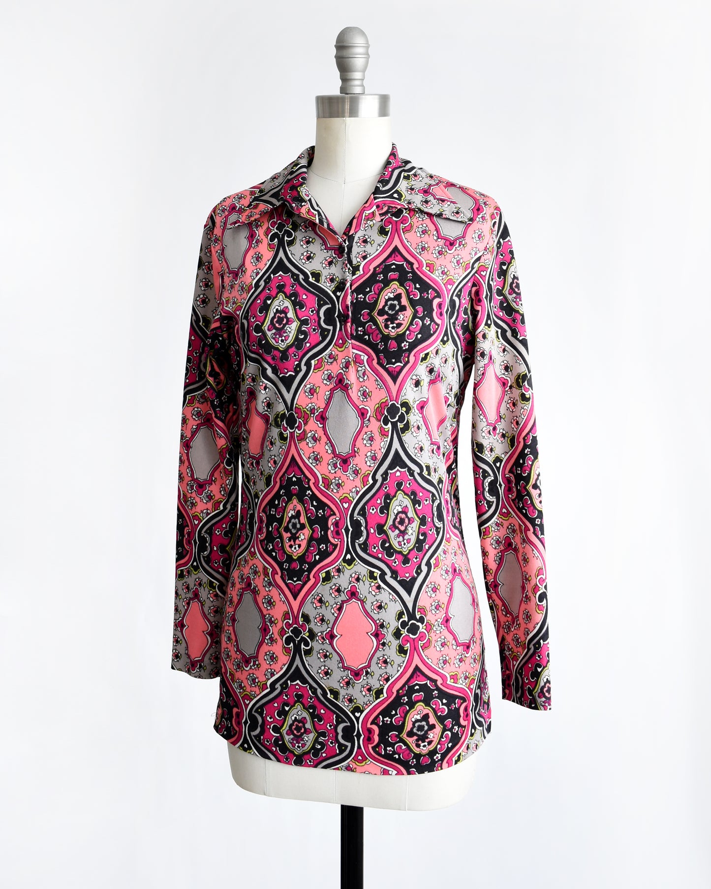 side front view of a vintage 1970s pink and black psychedelic floral blouse.
