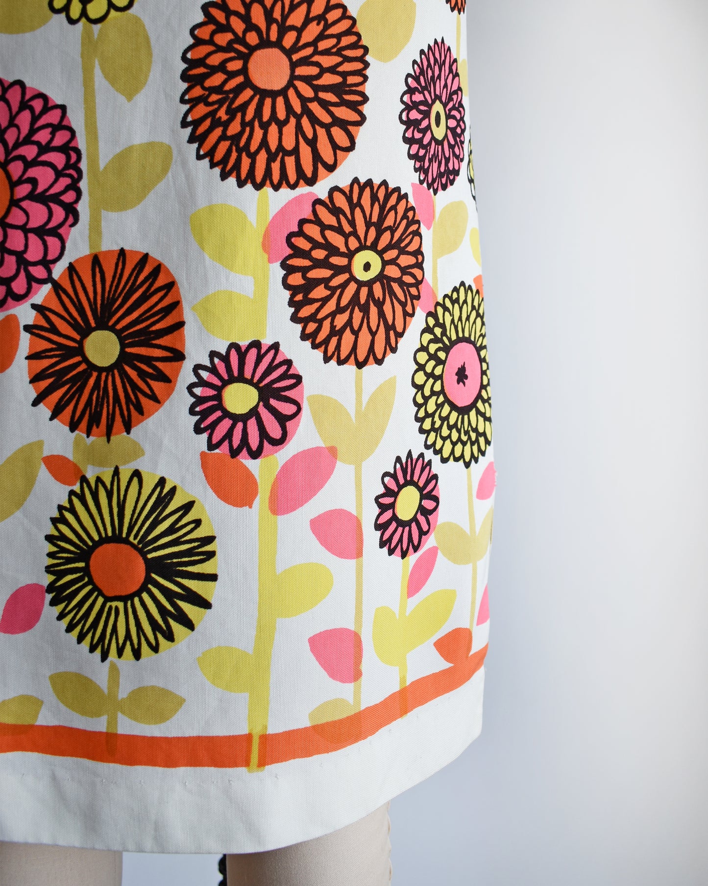 close up of the flower power print on a vintage 1960s flower power shift dress