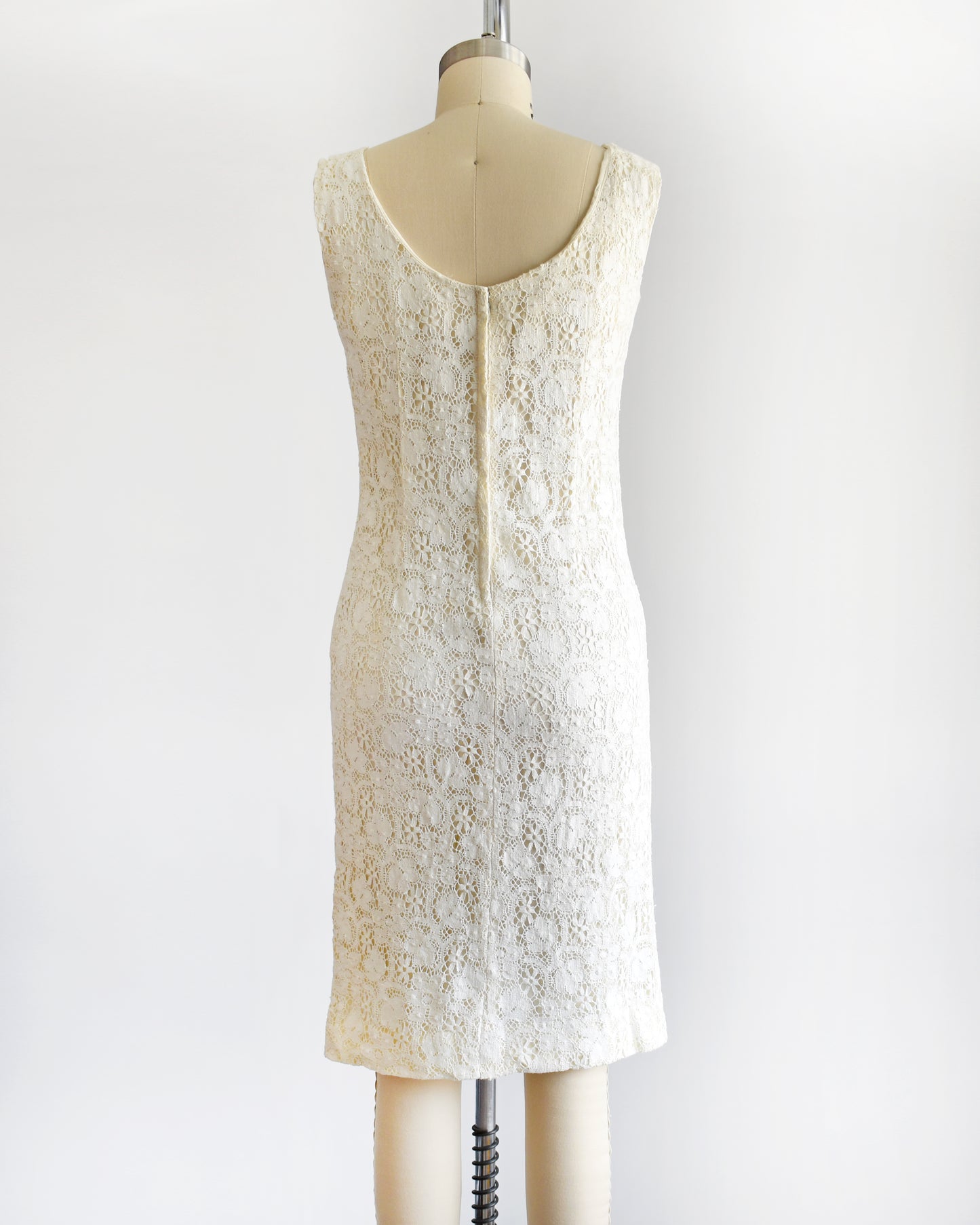 back view of a vintage 1960s floral cream lace dress