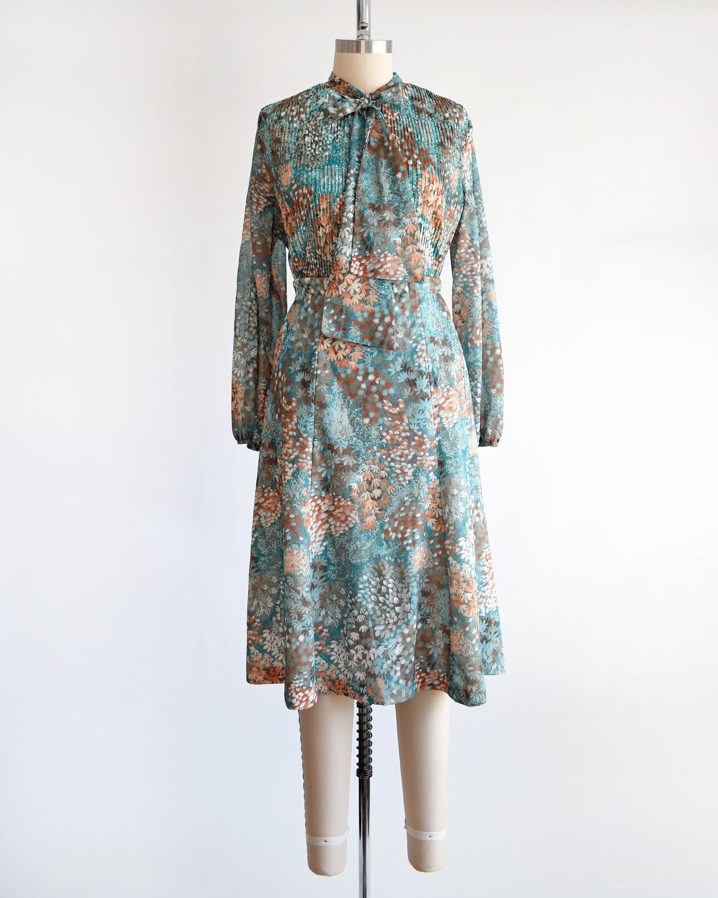 A vintage 1970s floral blue and orange floral dress set. This set comes with a matching blouse and skirt. 