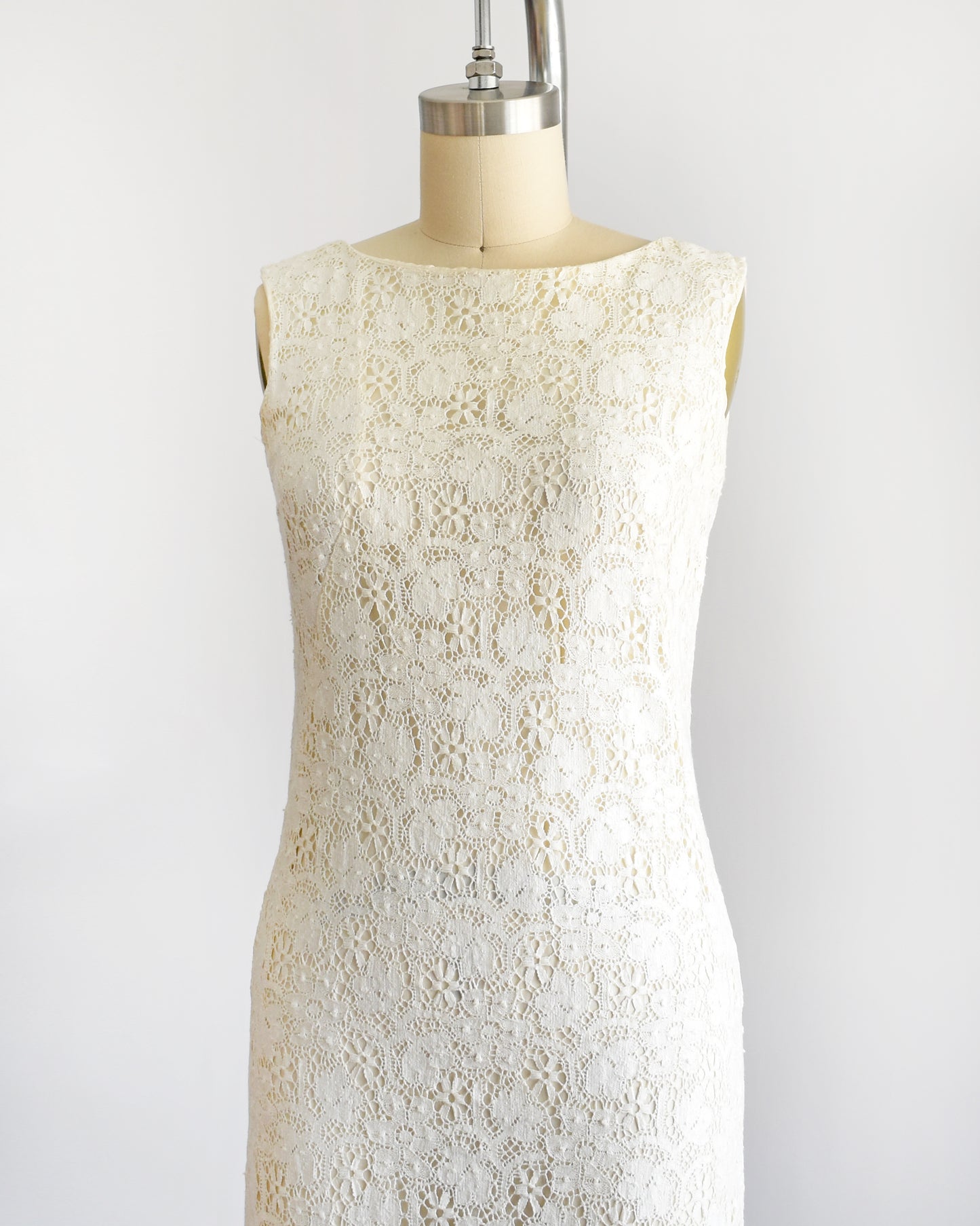 side front view of a vintage 1960s floral cream lace dress