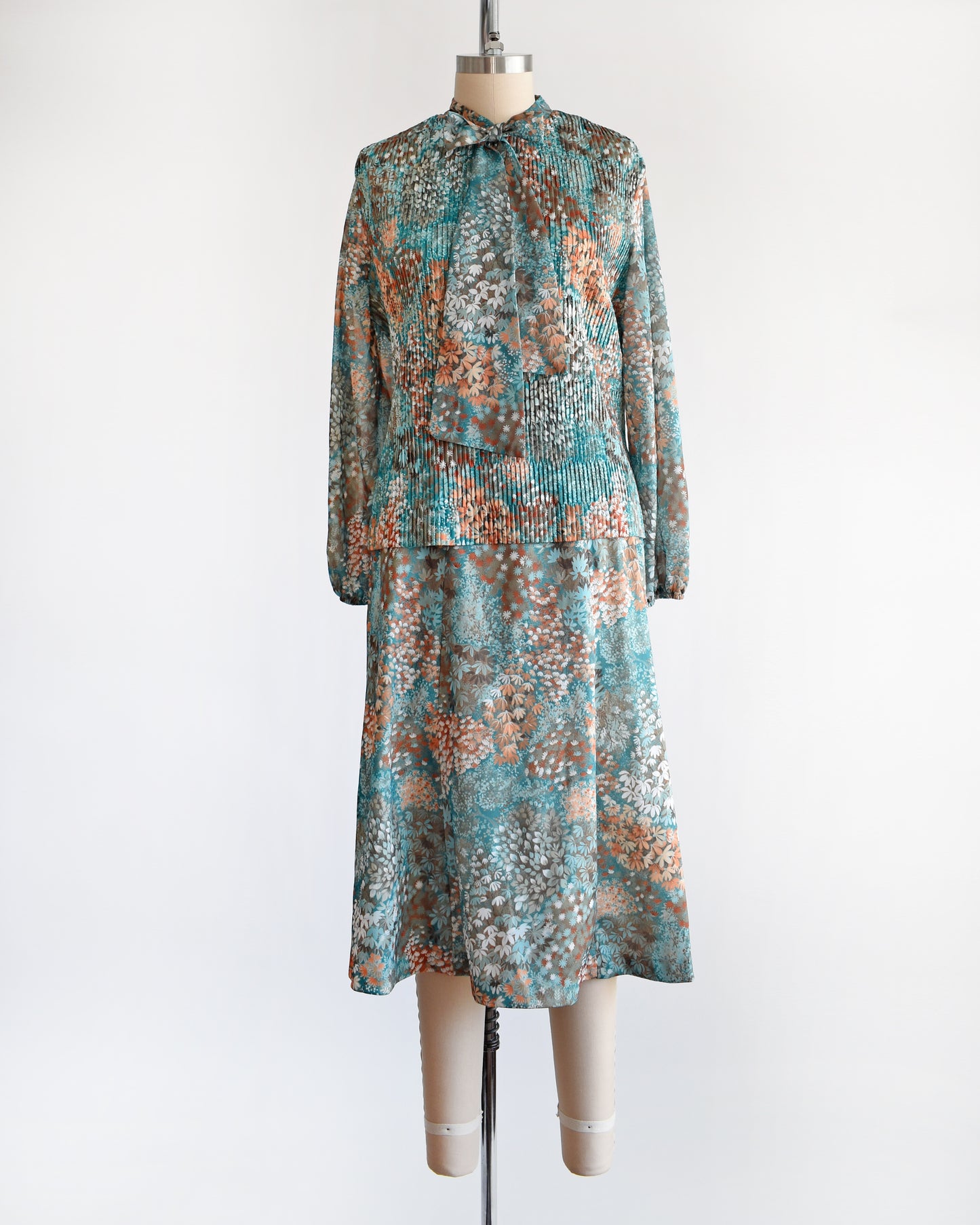 A vintage 1970s floral blue and orange floral dress set. This set comes with a matching blouse and skirt. 