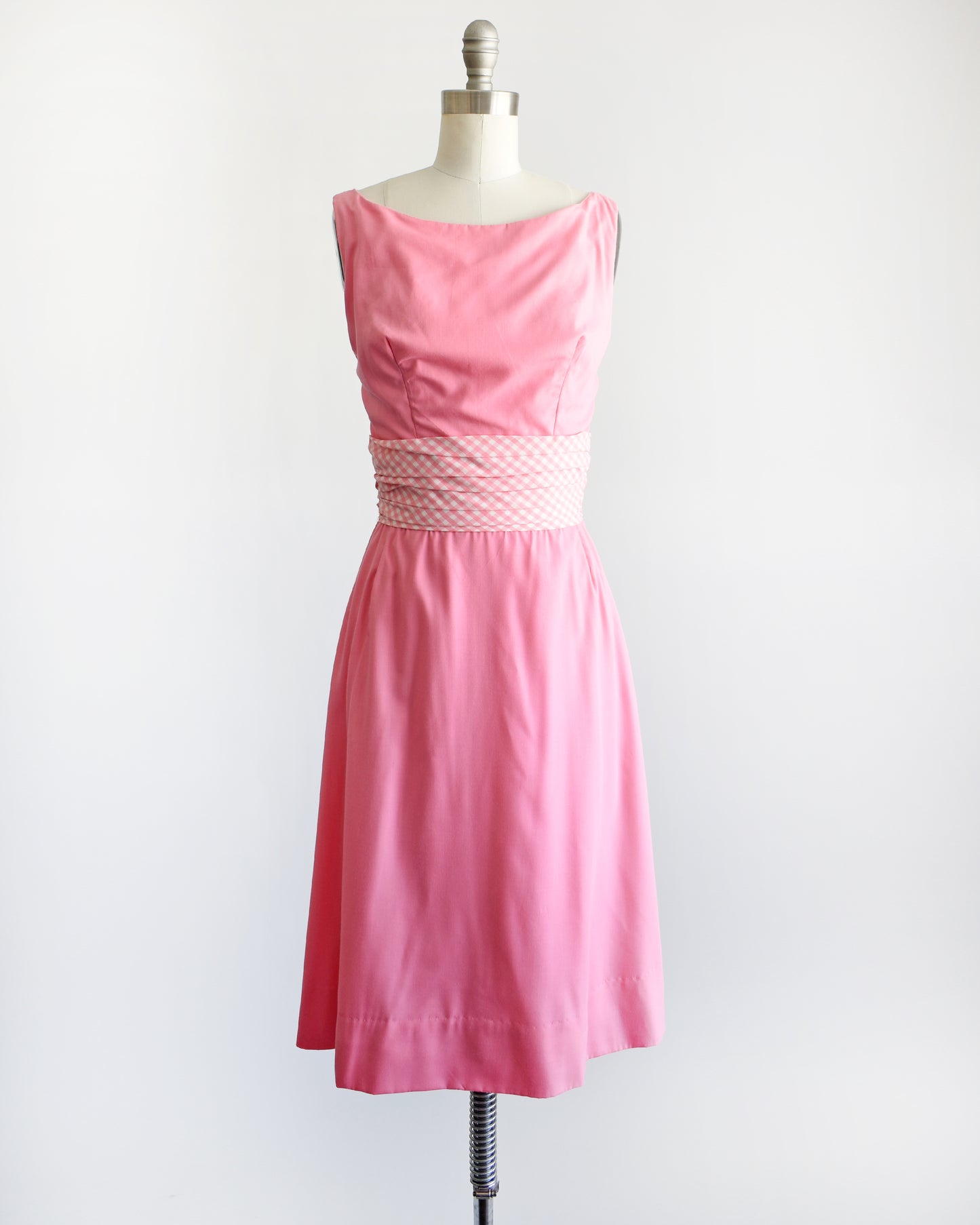 a vintage 1960s pink dress by Gigi Young that has a pink and white gingham waistband