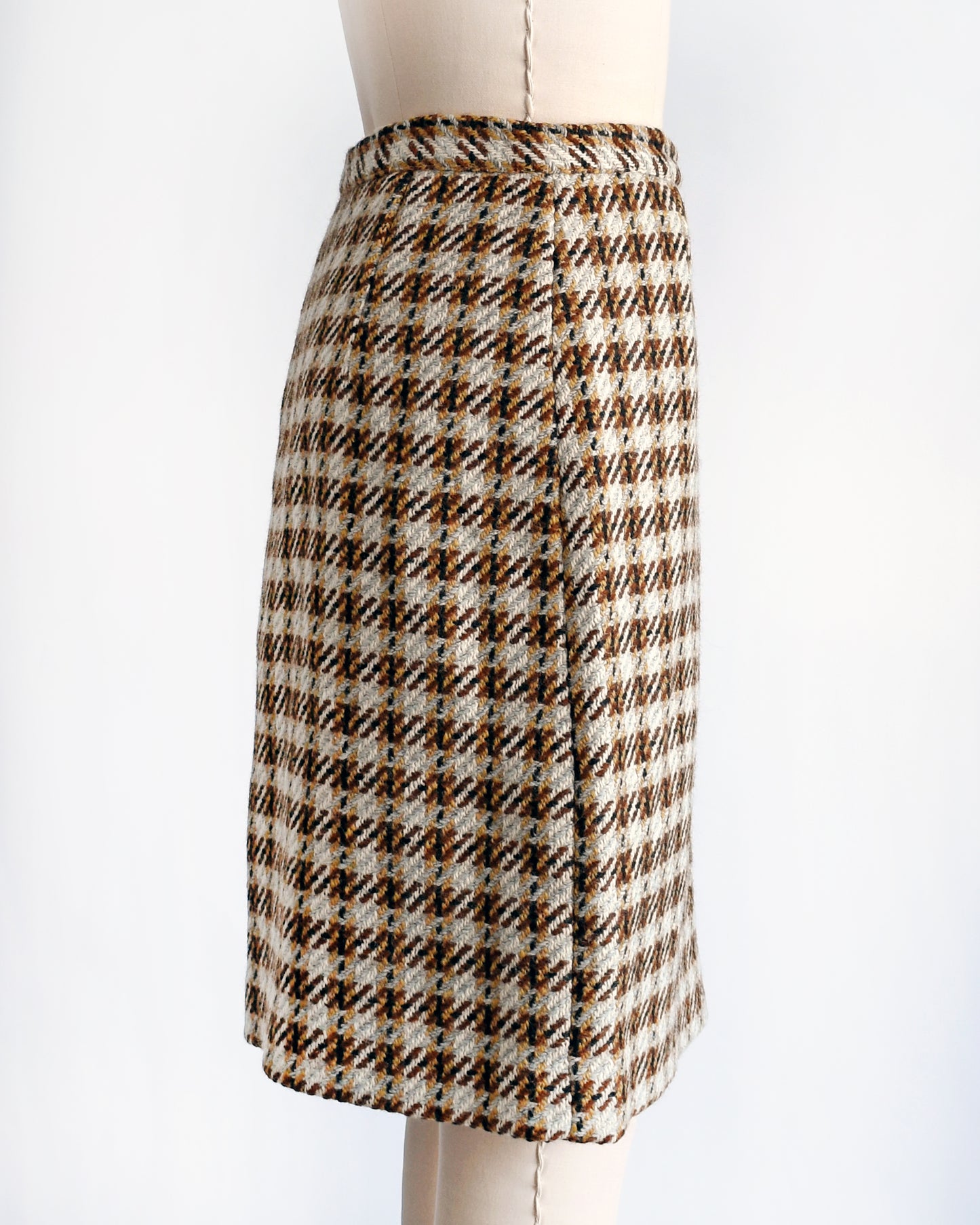 side view of a vintage 1960s brown plaid wool skirt