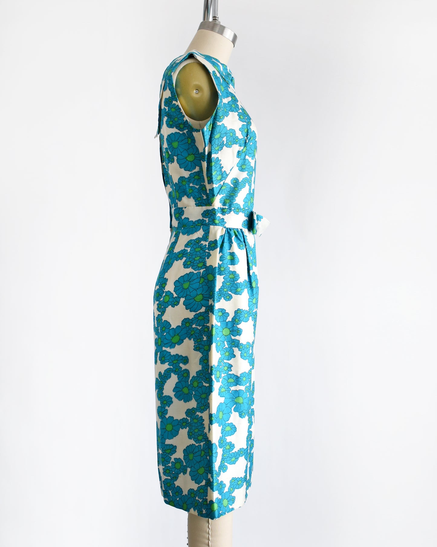 side view of a vintage 1960s blue and white floral dress on a dress form