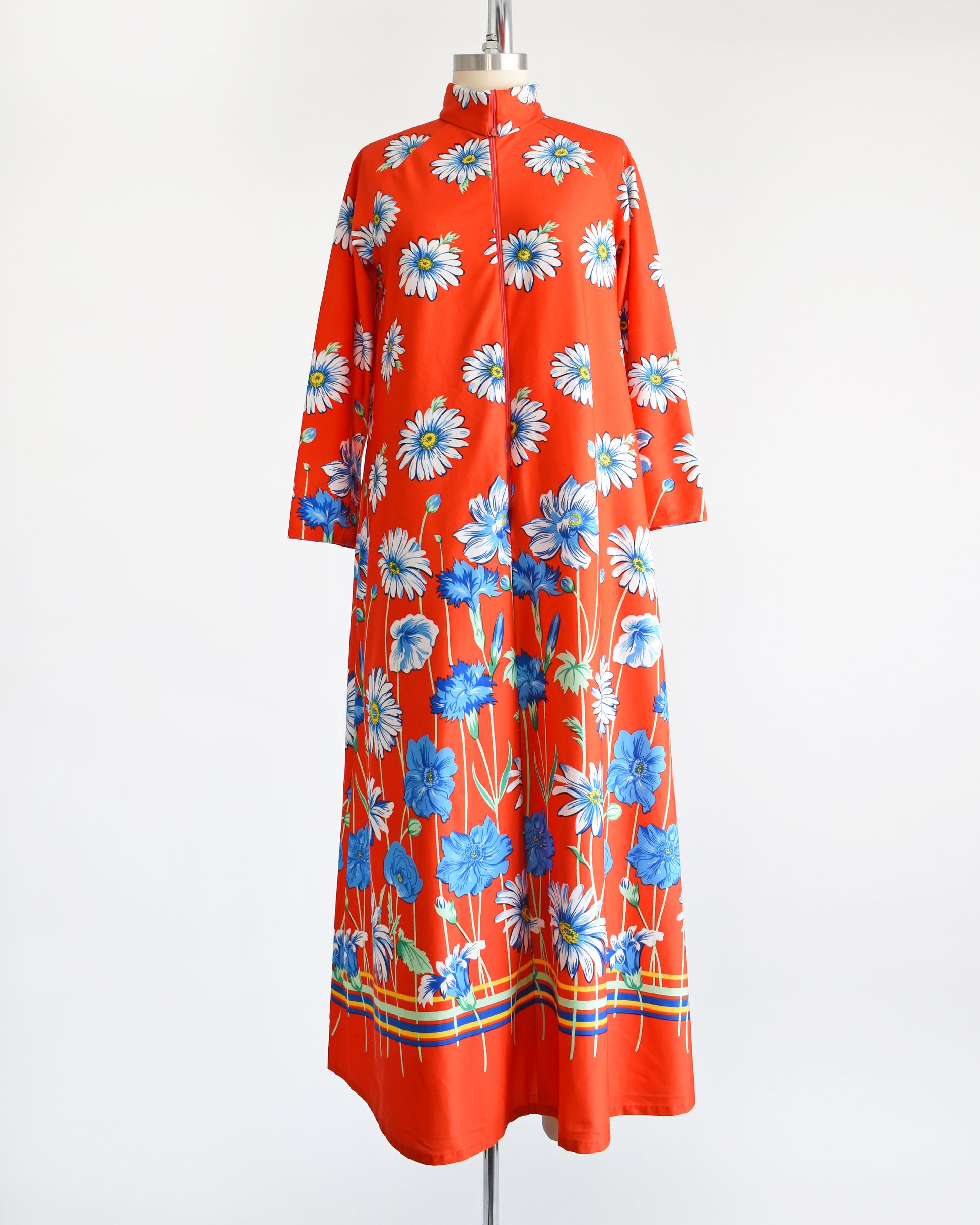 A vintage 1970s red floral lounge dress with a zipper down the front. 