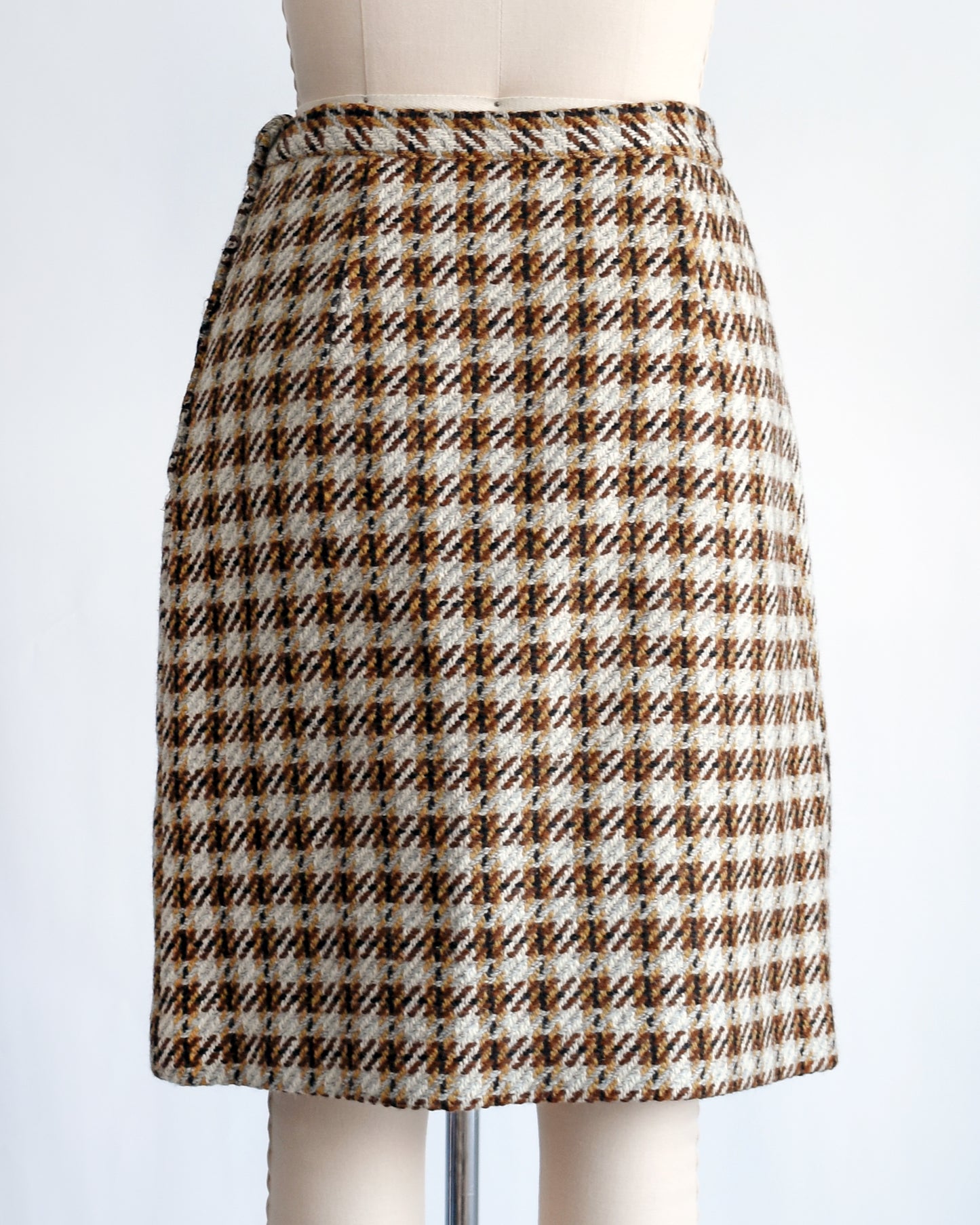 back view of a vintage 1960s brown plaid wool skirt