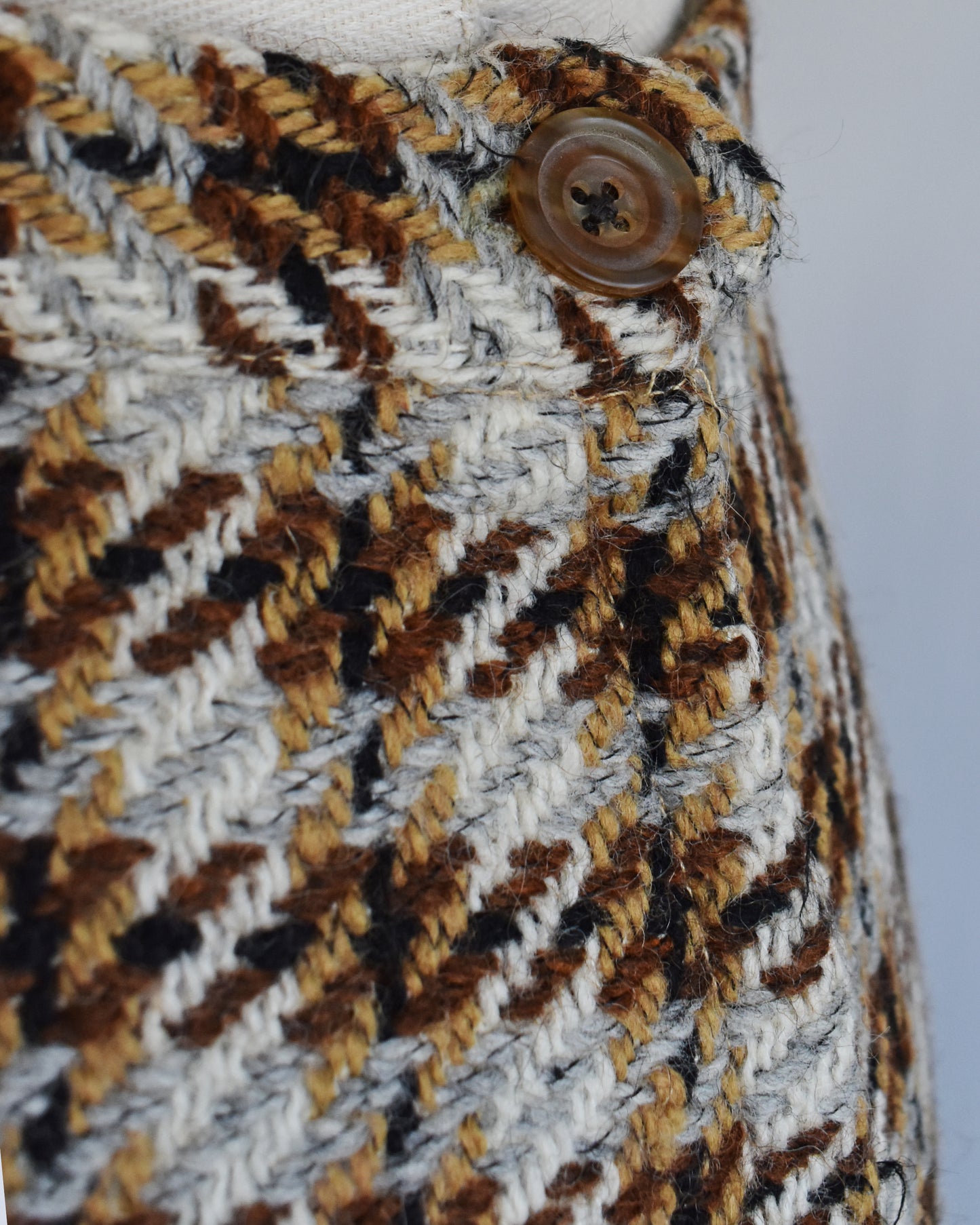 close up of the side button and plaid wool