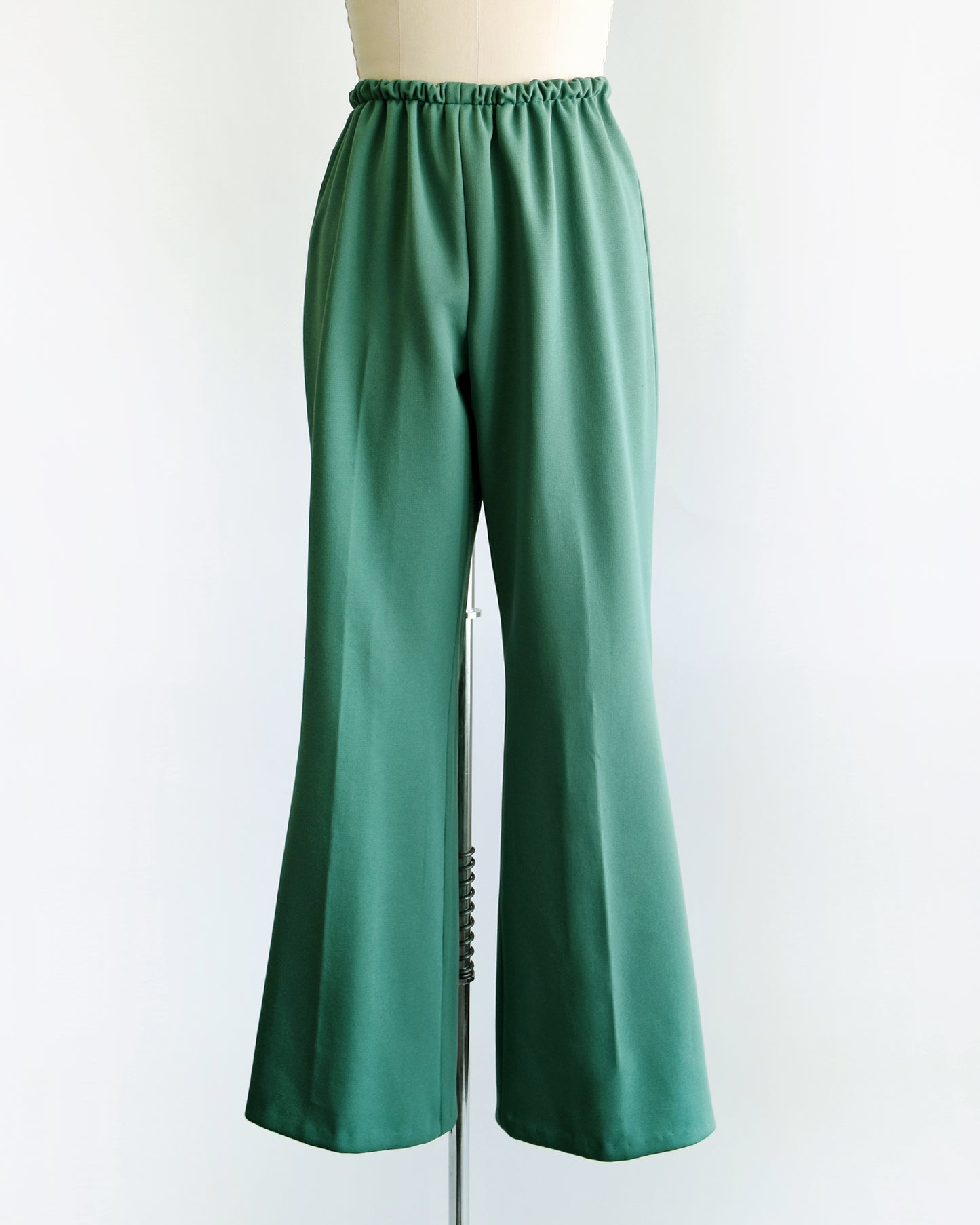 a pair of vintage 1970s green wide leg pants on a dress form