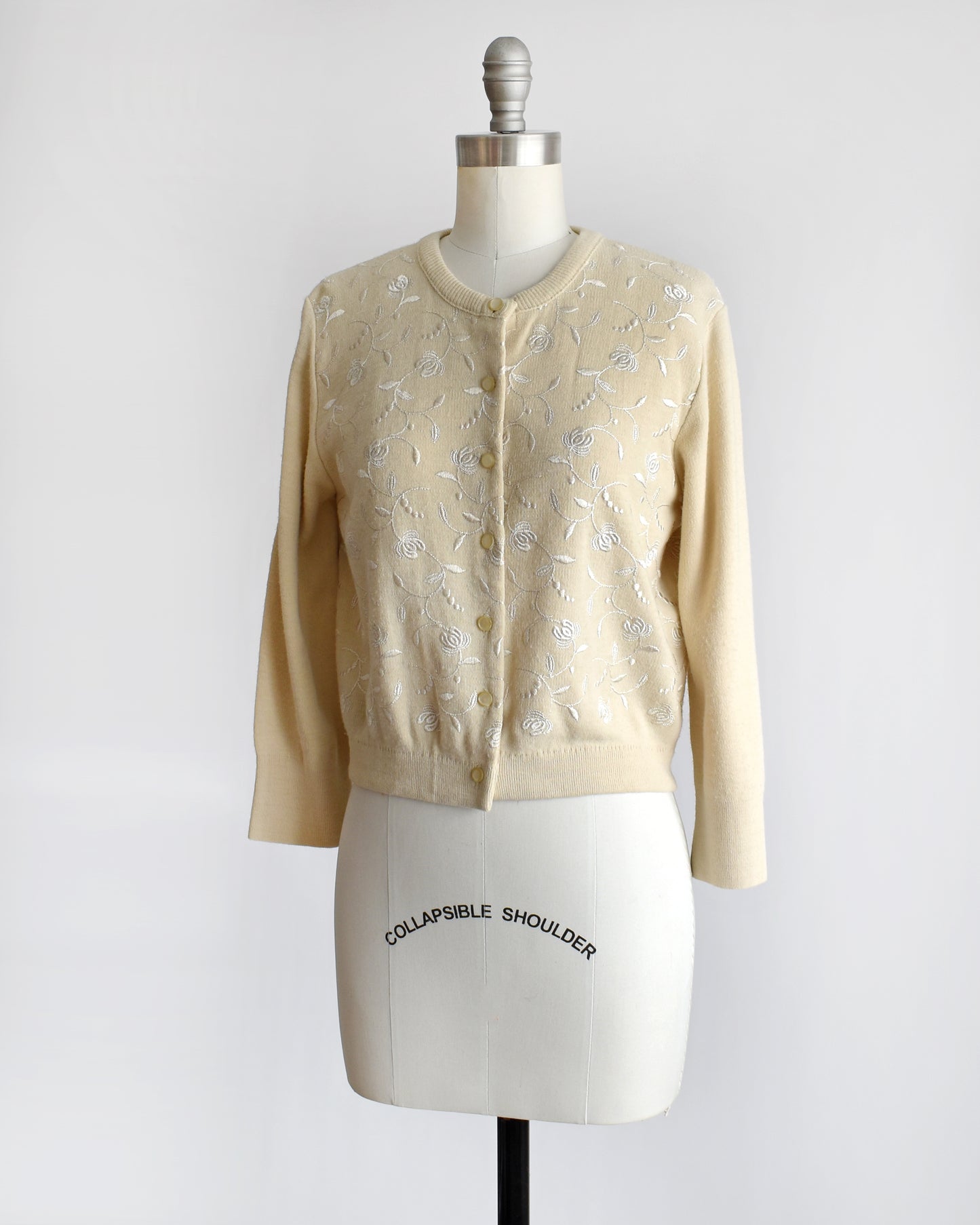 side front view of a a vintage 1960s embroidered floral cardigan