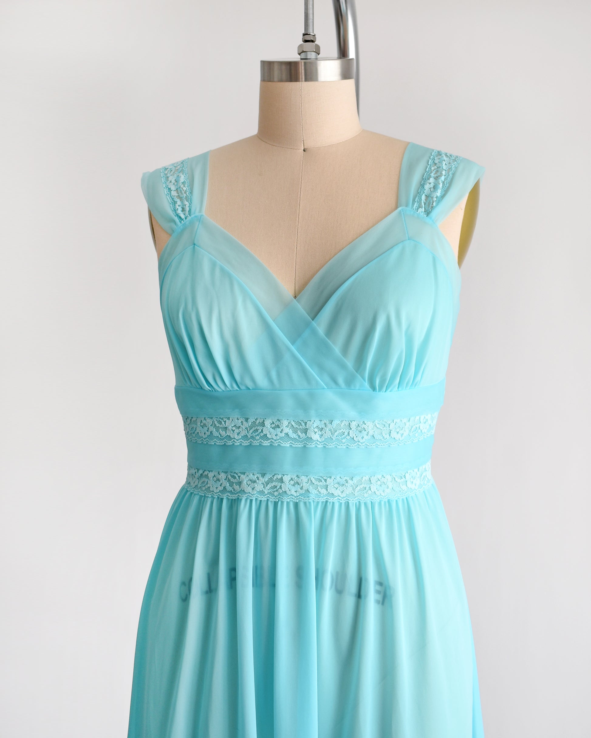 Side view of a vintage 1960s aqua blue lace nightgown with lace trim