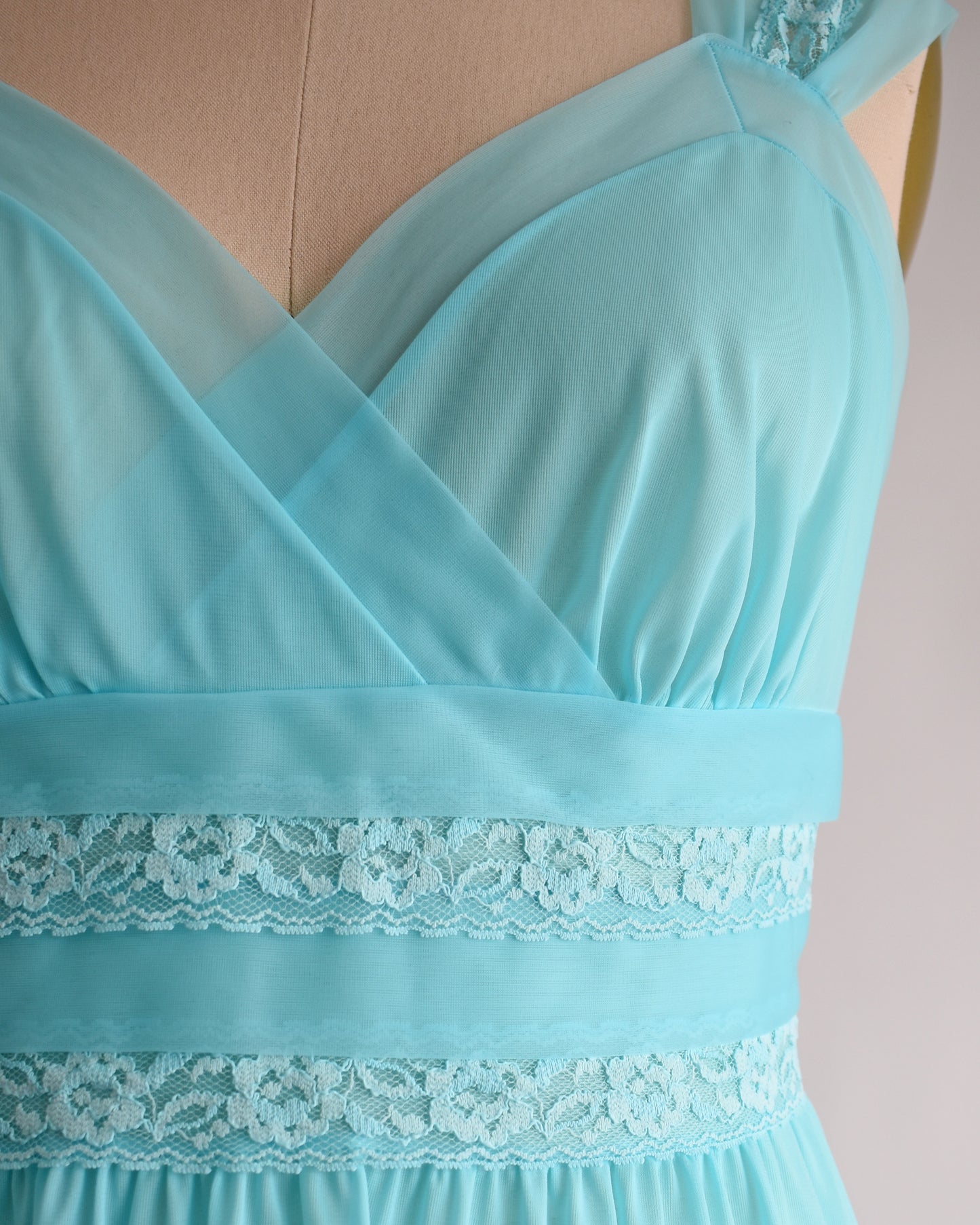 Close up of a vintage 1960s aqua blue lace nightgown with lace trim
