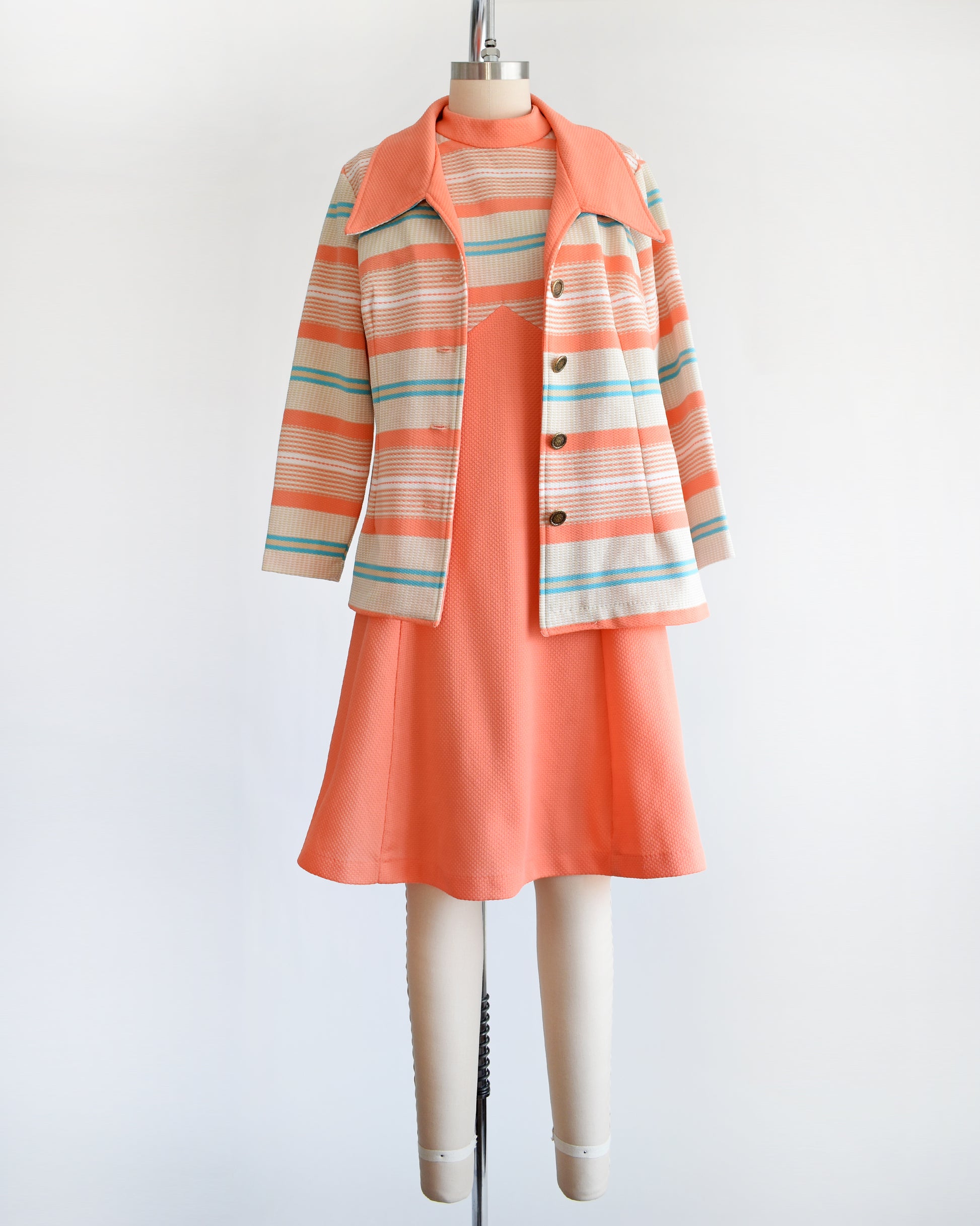 A vintage 1970s peach and blue mod dress set. This set comes with a peach, tan, blue, and white horizontal striped jacket and matching dress.