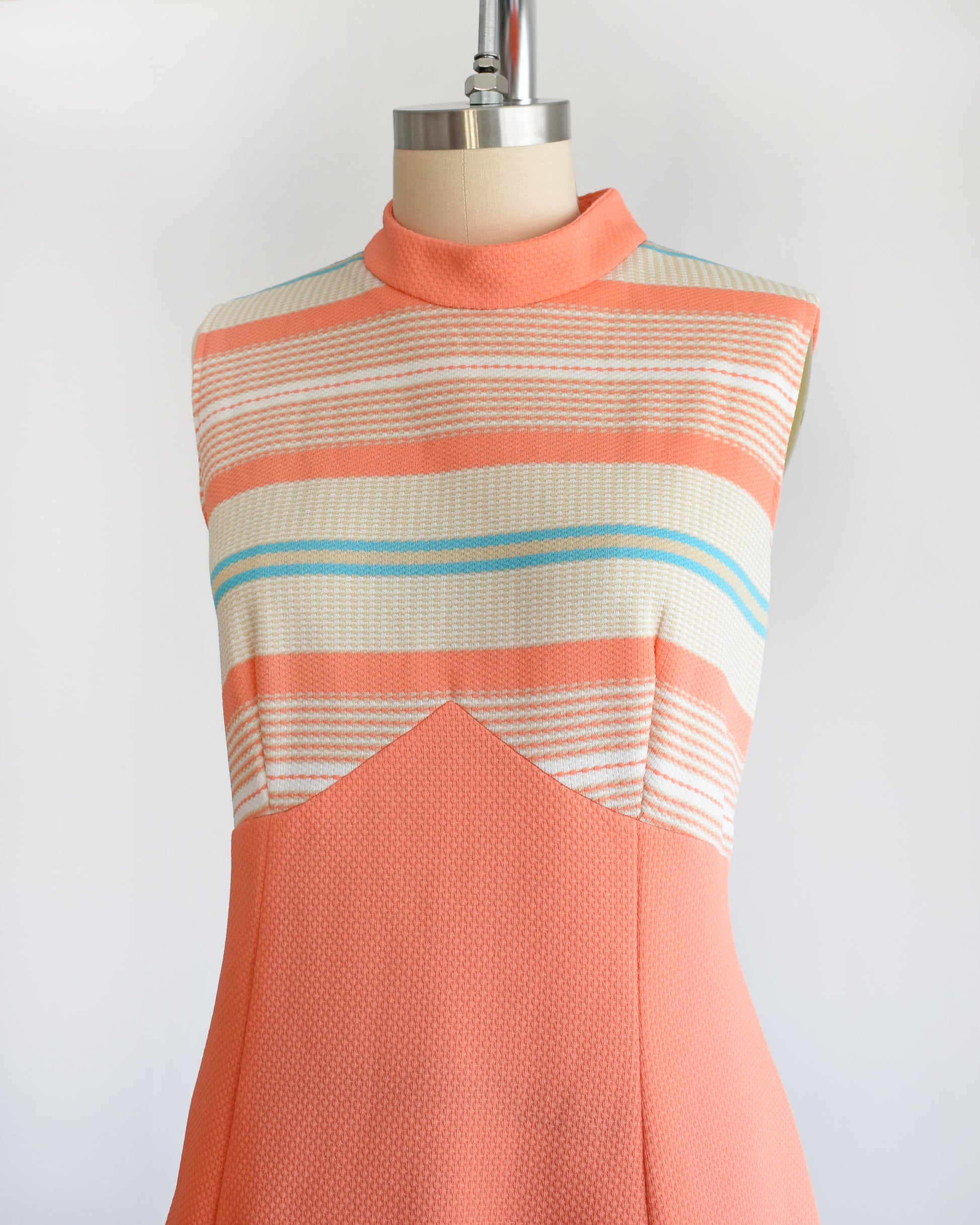 Side view of a vintage 1970s peach and blue mod dress set.