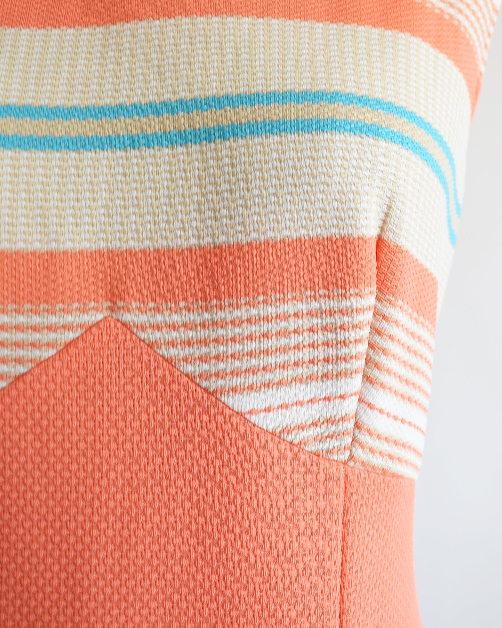 Close up of the bodice of the dress which shows the horizontal stripes