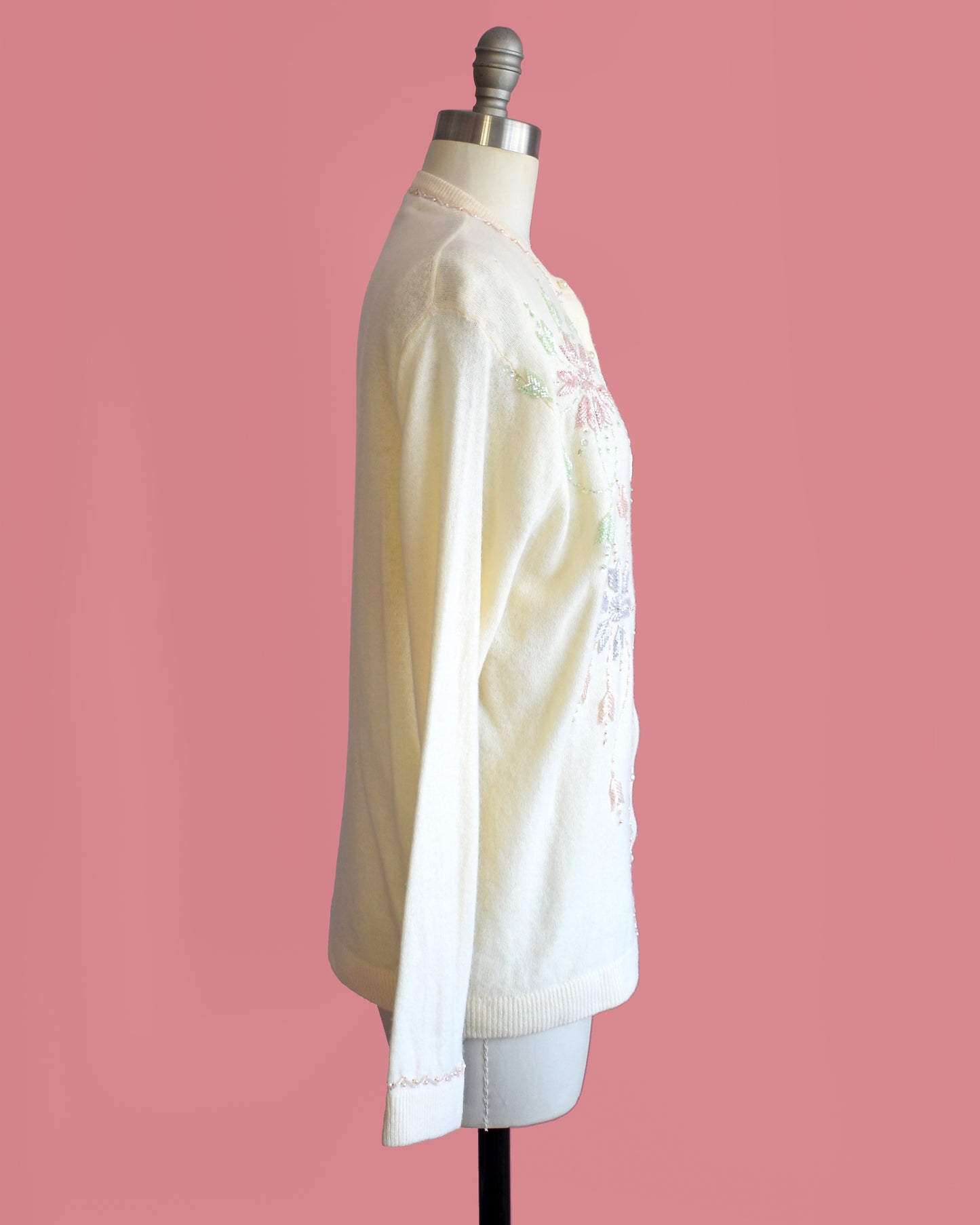 side view of a a vintage 1960s cream beaded floral cardigan.