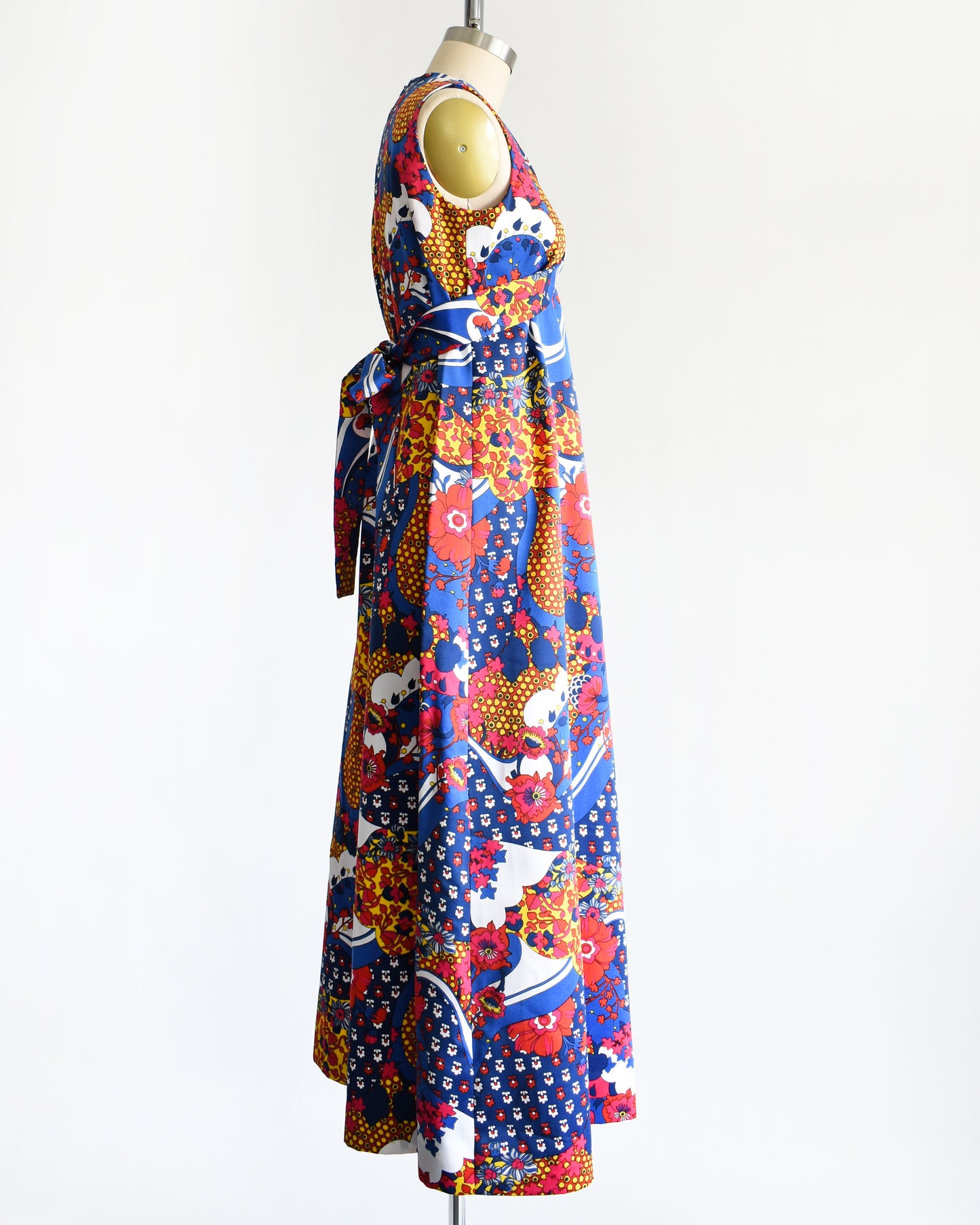 side view of a vintage 1970s blue and multicolored floral print maxi dress