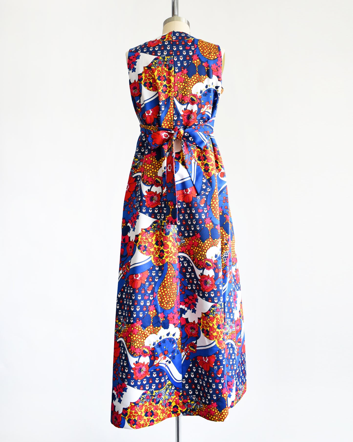 back view of a vintage 1970s blue and multicolored floral print maxi dress