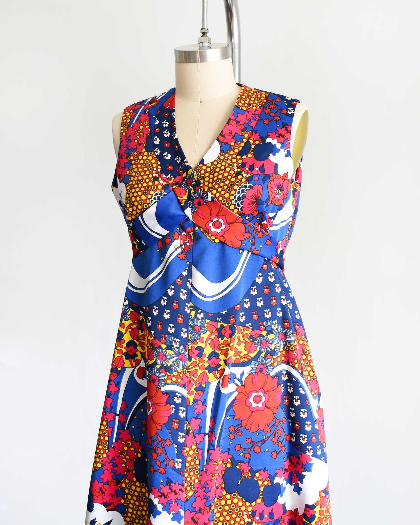 side front view of a vintage 1970s blue and multicolored floral print maxi dress