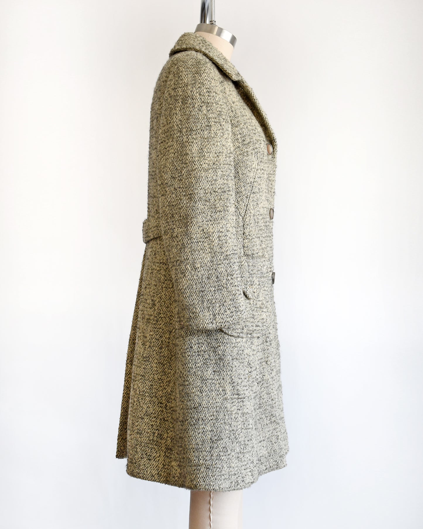 side view of a vintage 1960s gray and cream wool bouclé coat.