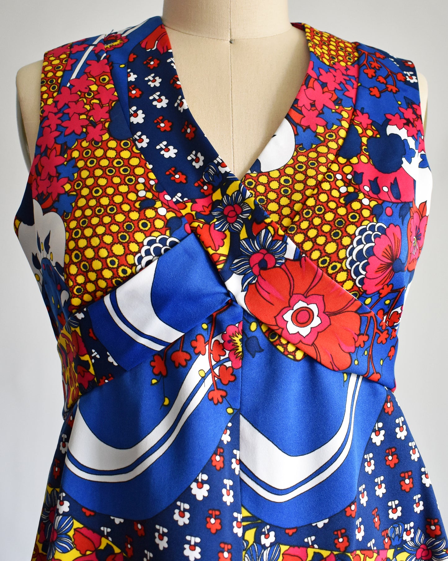 close up of the bodice on a vintage 1970s blue and multicolored floral print maxi dress