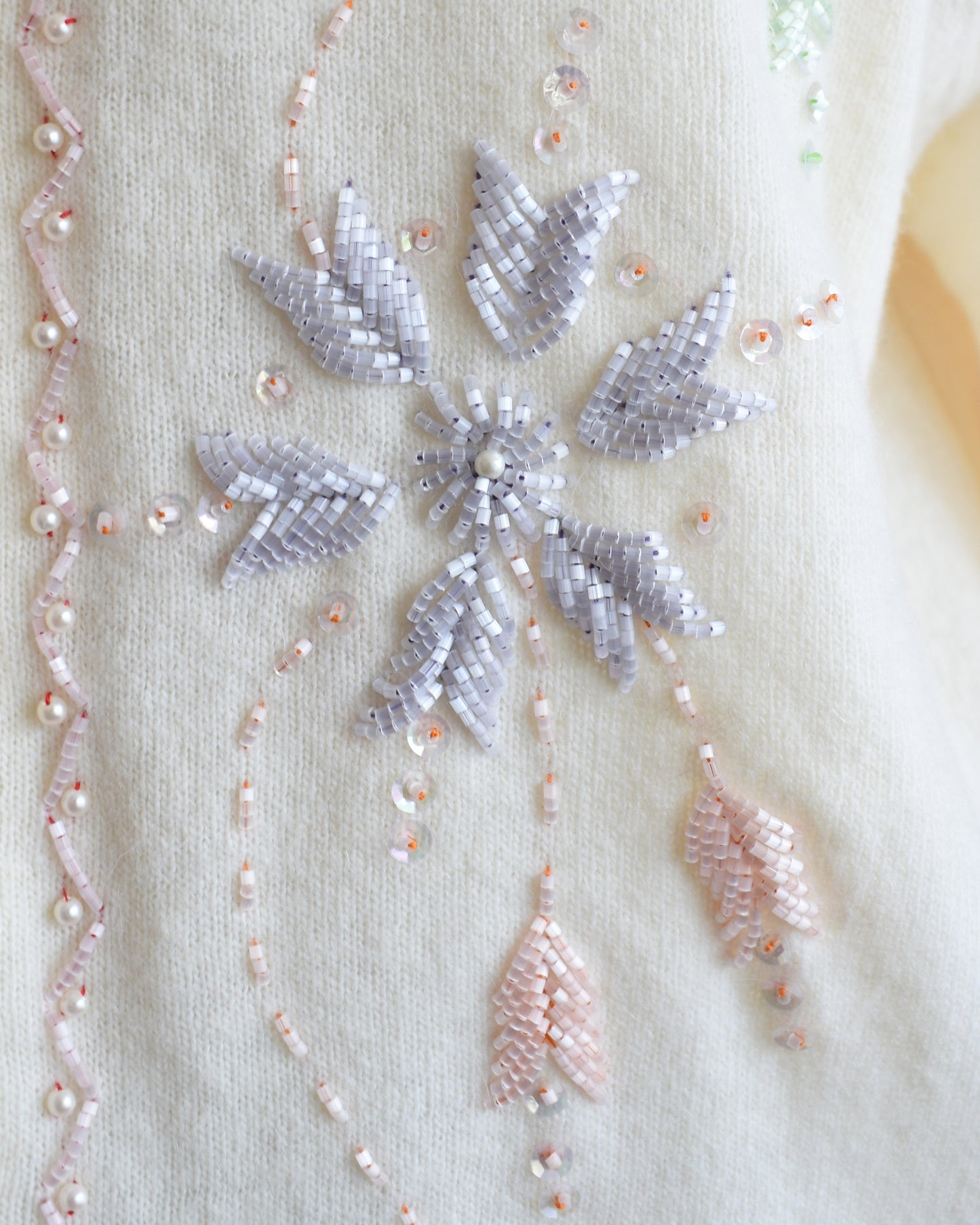 close up of the beaded floral detail on the cardigan