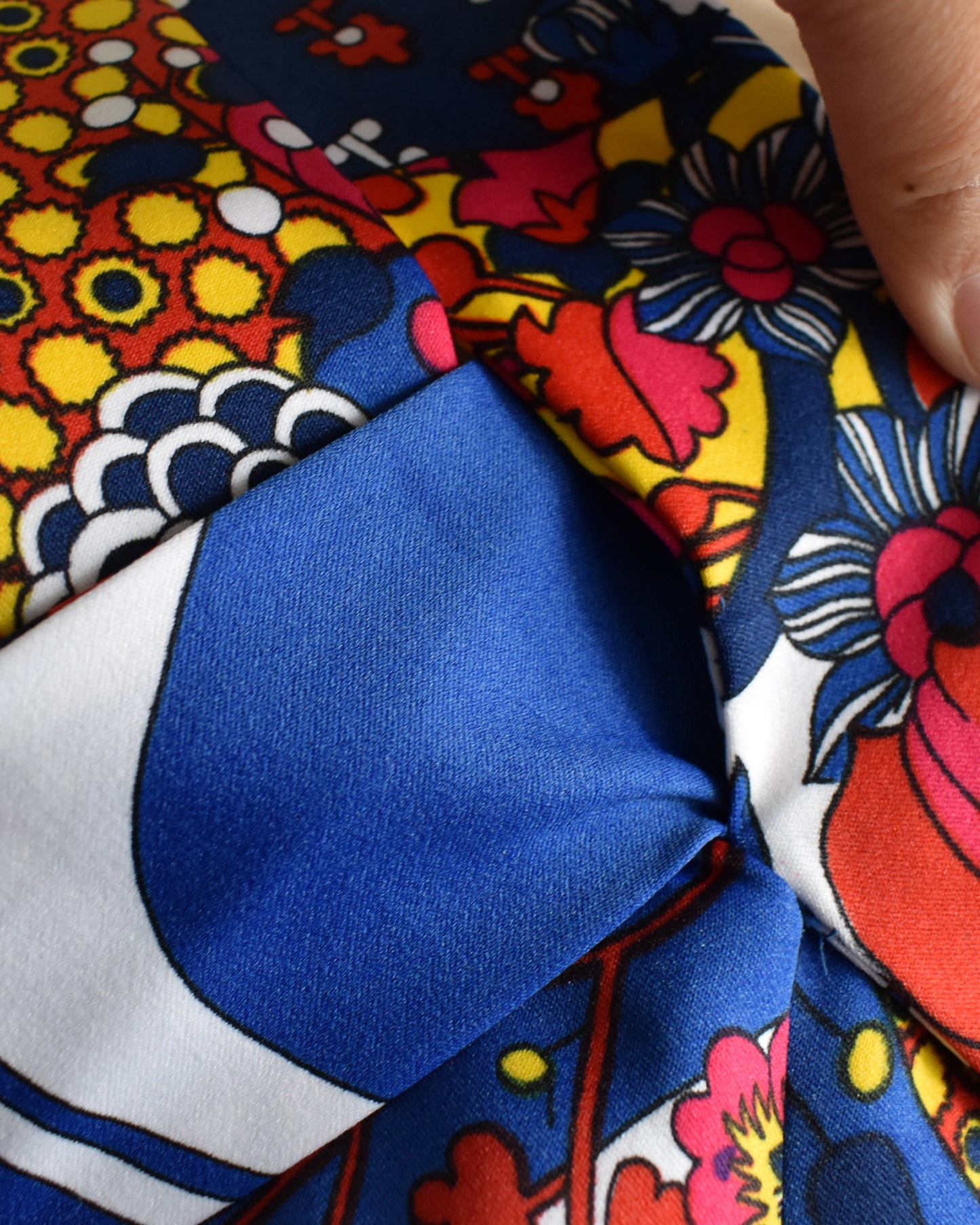close up of the empire waist tie that loops under and ties in the back of the dress