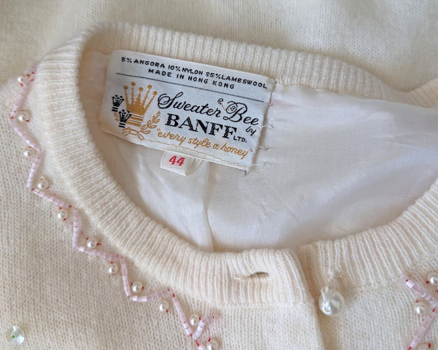 close up of the tag which says Sweater Bee by Banff LTD