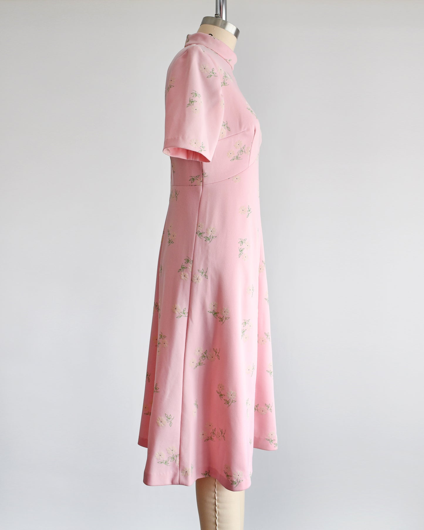 side view of a vintage 1960s pink and white floral mod dress.