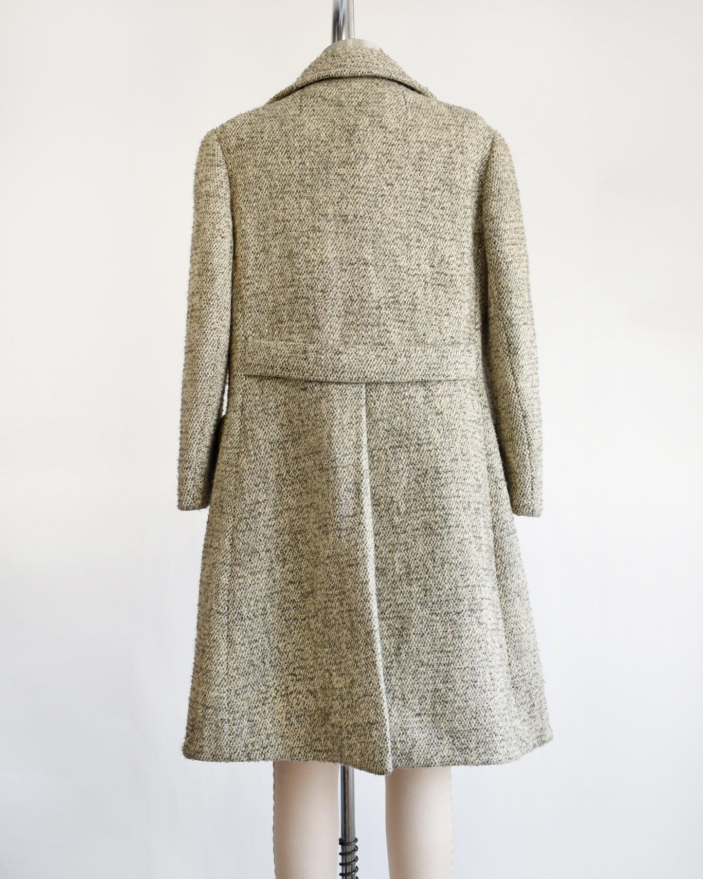 back view of a vintage 1960s gray and cream wool bouclé coat.