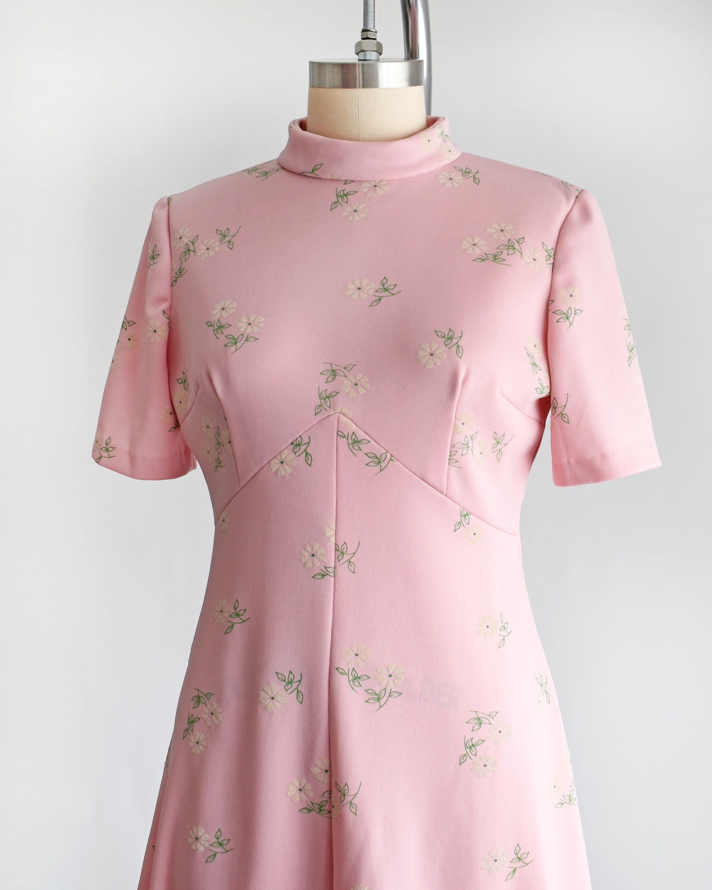 side front view of a vintage 1960s pink and white floral mod dress.