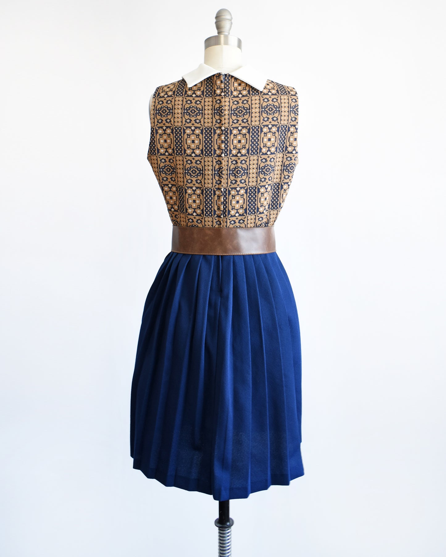 Back view of a vintage 1960s brown, blue, and white mod scooter dress.