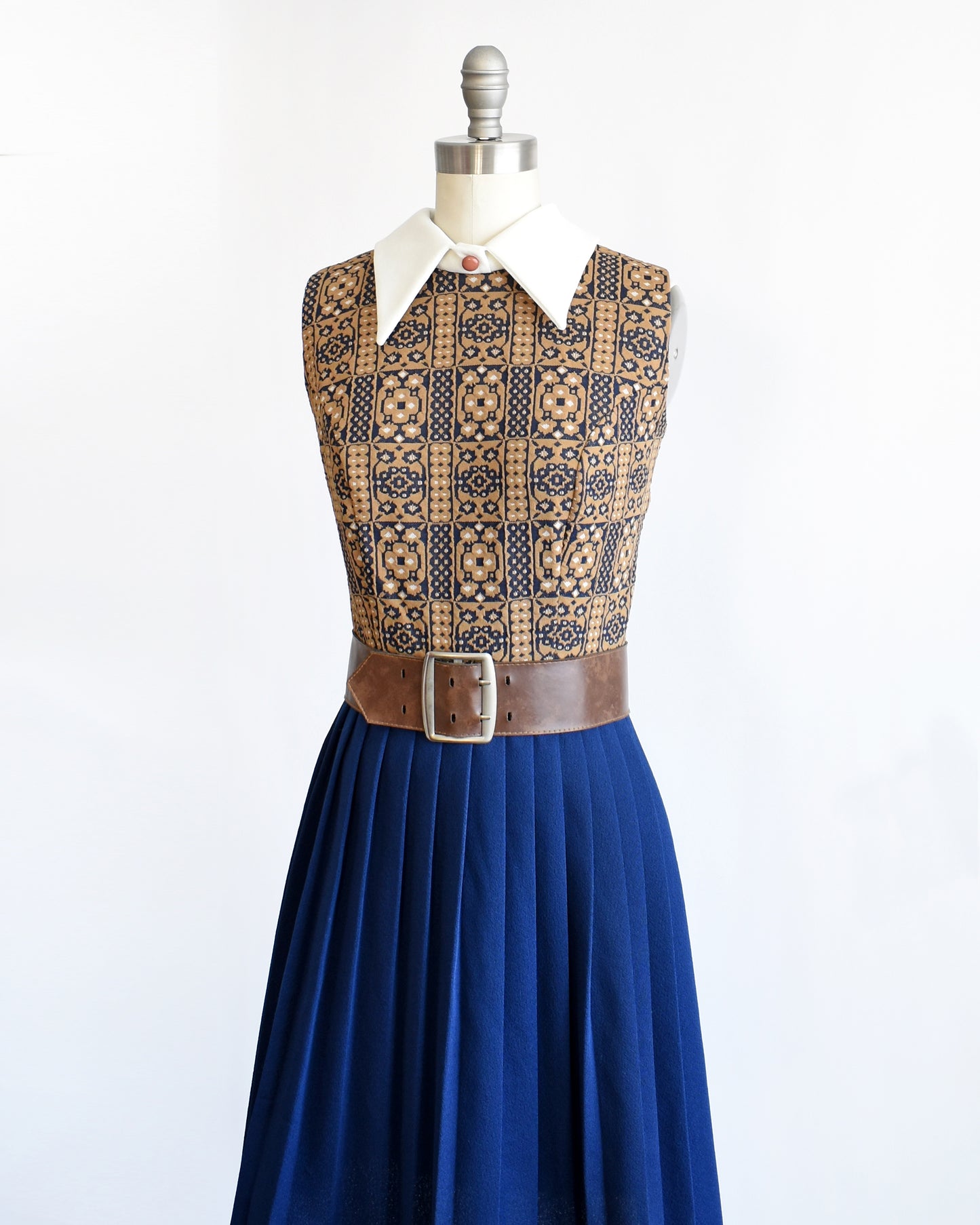 Side front view of a vintage 1960s brown, blue, and white mod scooter dress.