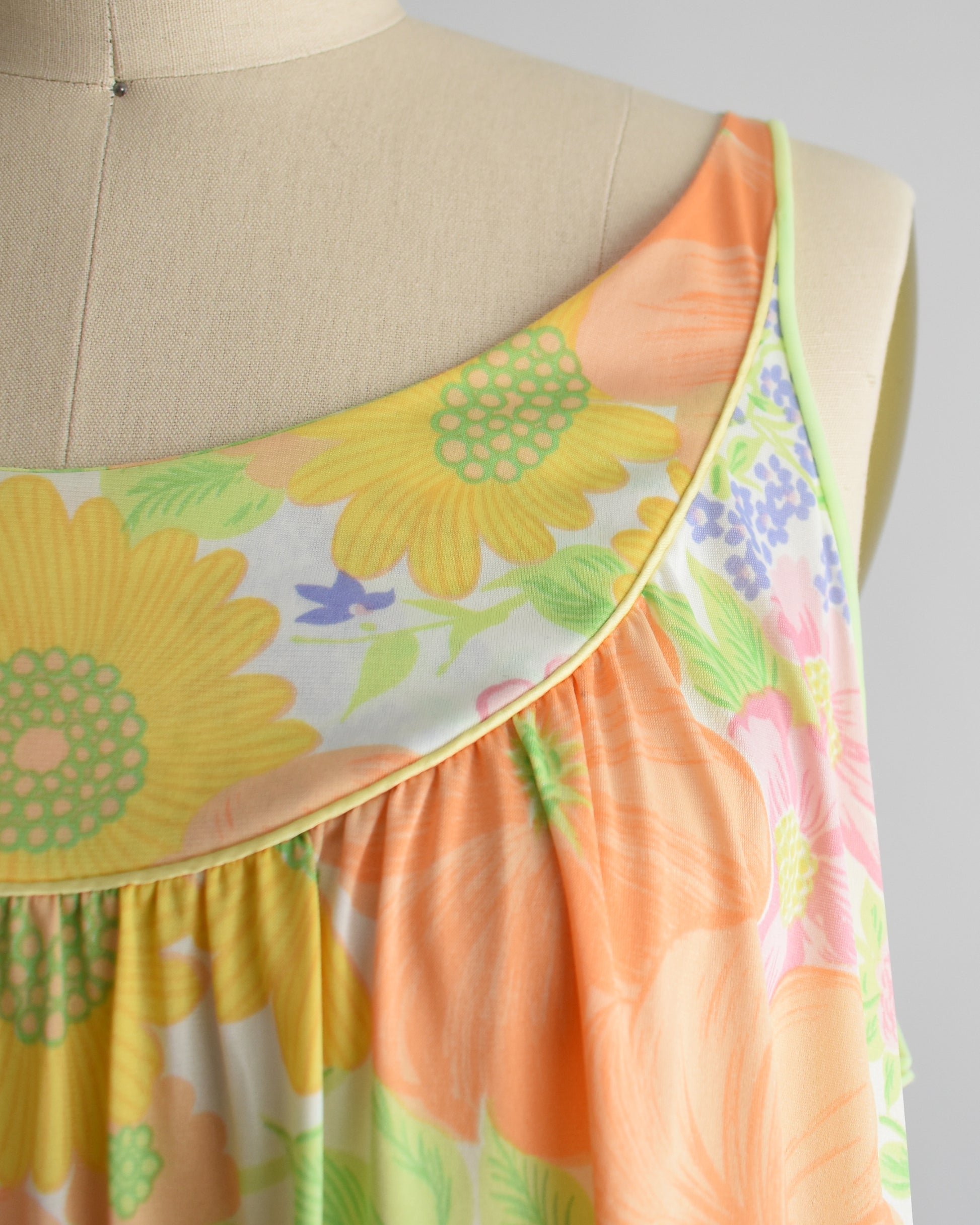 Close up of the green and yellow trim on the floral nightgown
