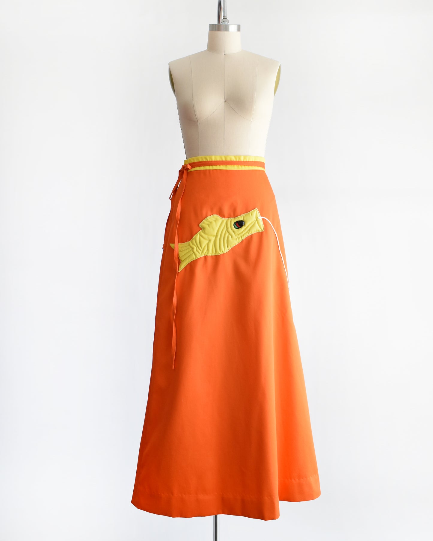 A vintage 1970s fish kite appliqué orange and yellow wrap skirt.