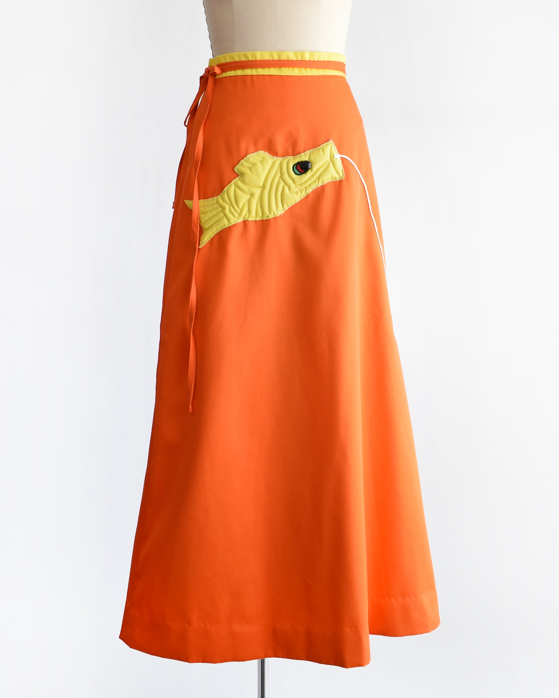 A vintage 1970s fish kite appliqué orange and yellow wrap skirt.