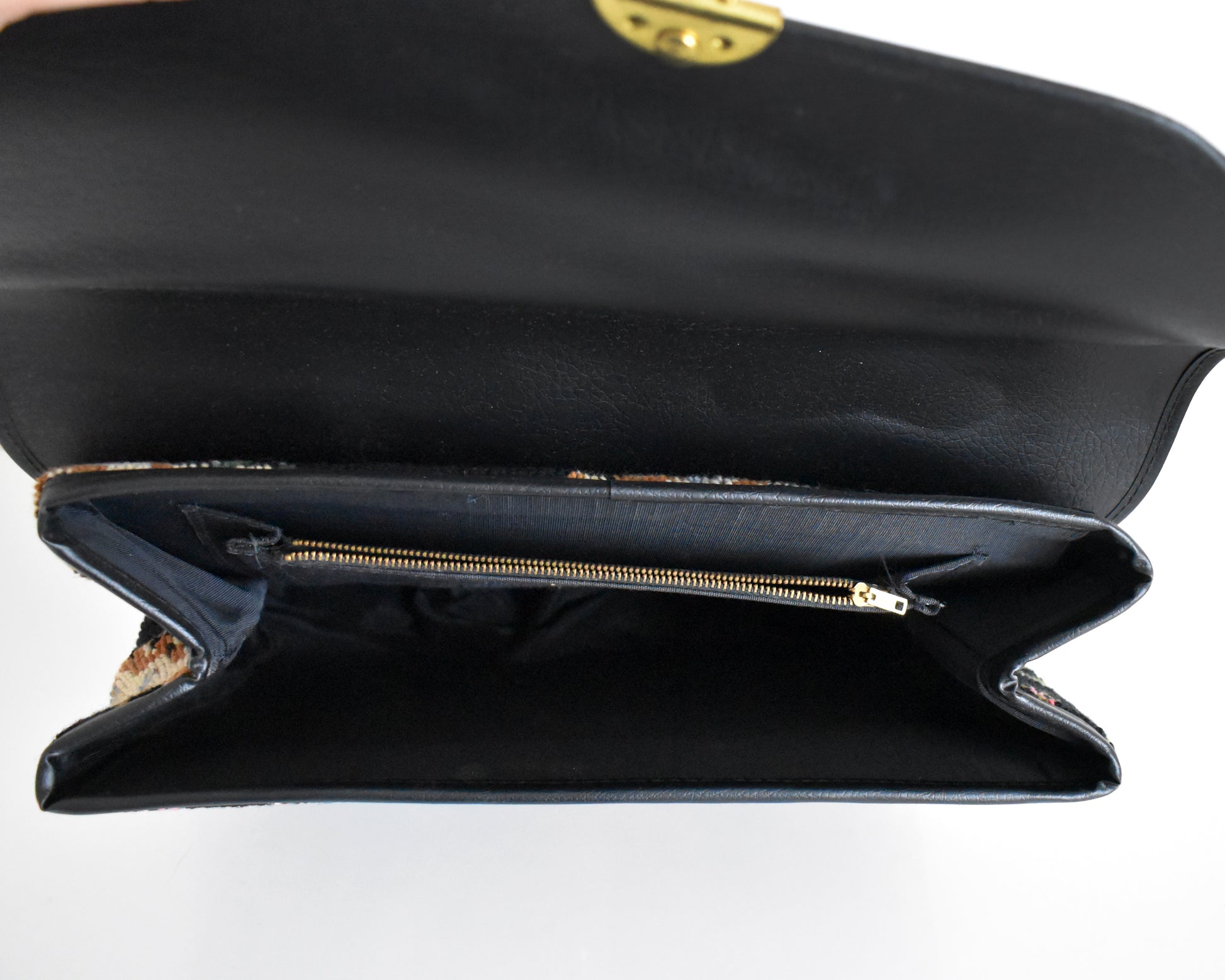 inside shot of the purse which shows the black lining and zippered pocket