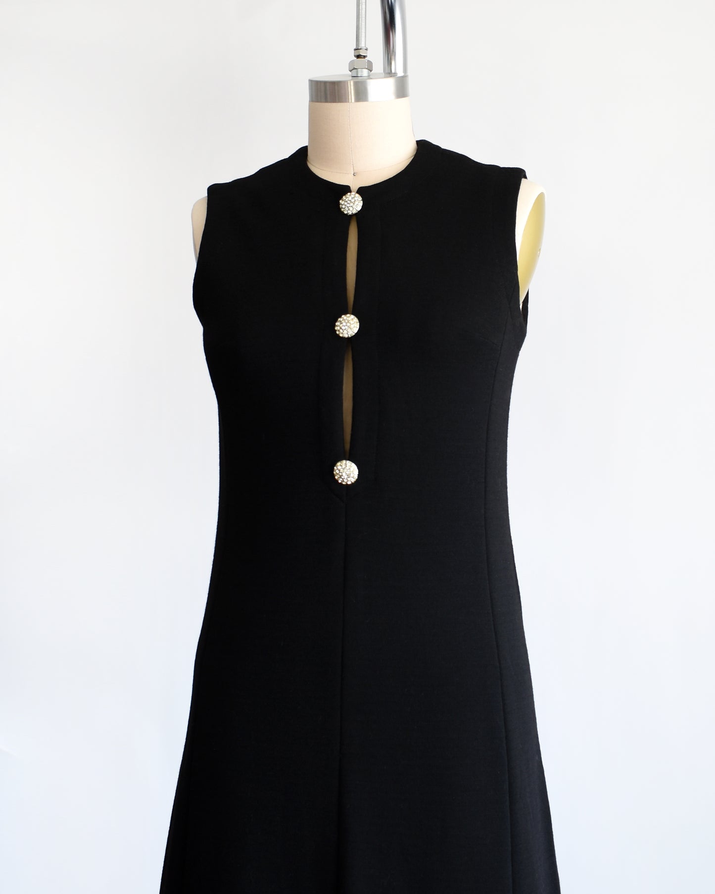 side front view of  a vintage 1960s black keyhole rhinestone dress
