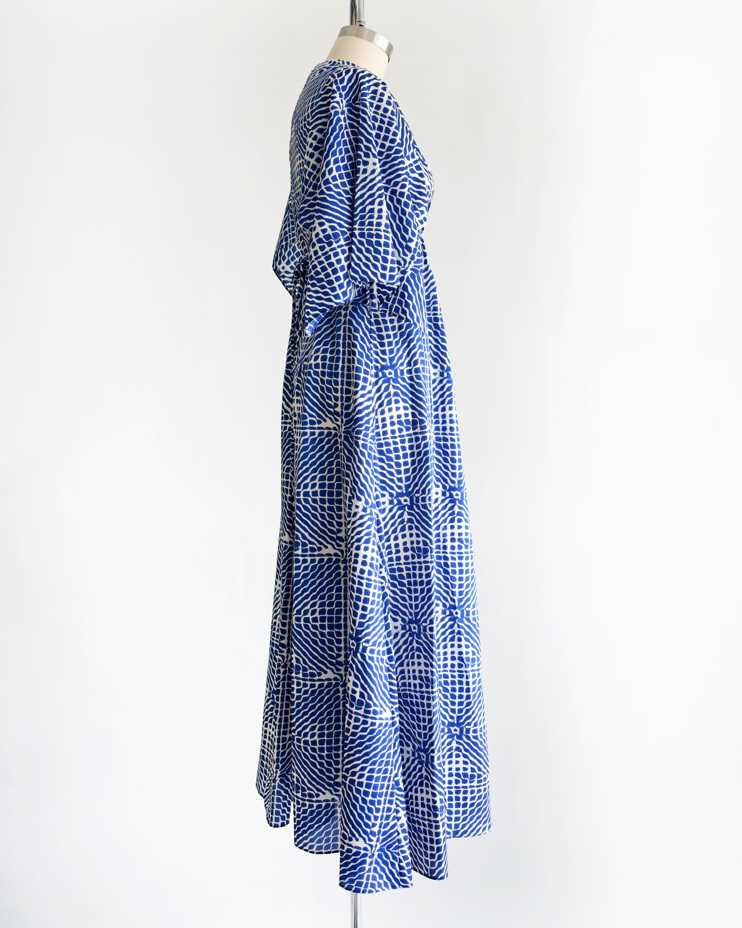 side view of a vintage 1970s blue and white caftan with handkerchief sleeves
