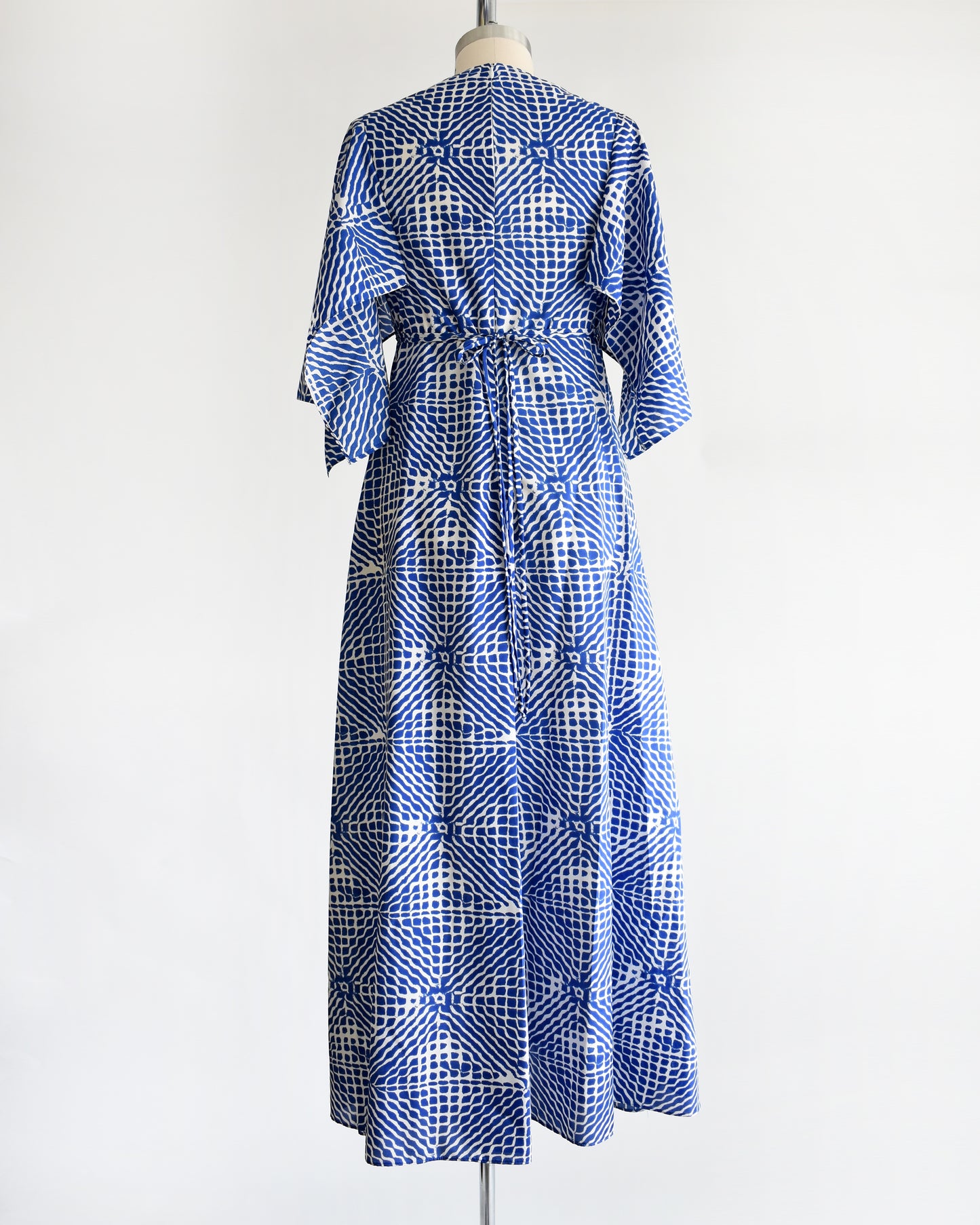 back view of a vintage 1970s blue and white caftan with handkerchief sleeves