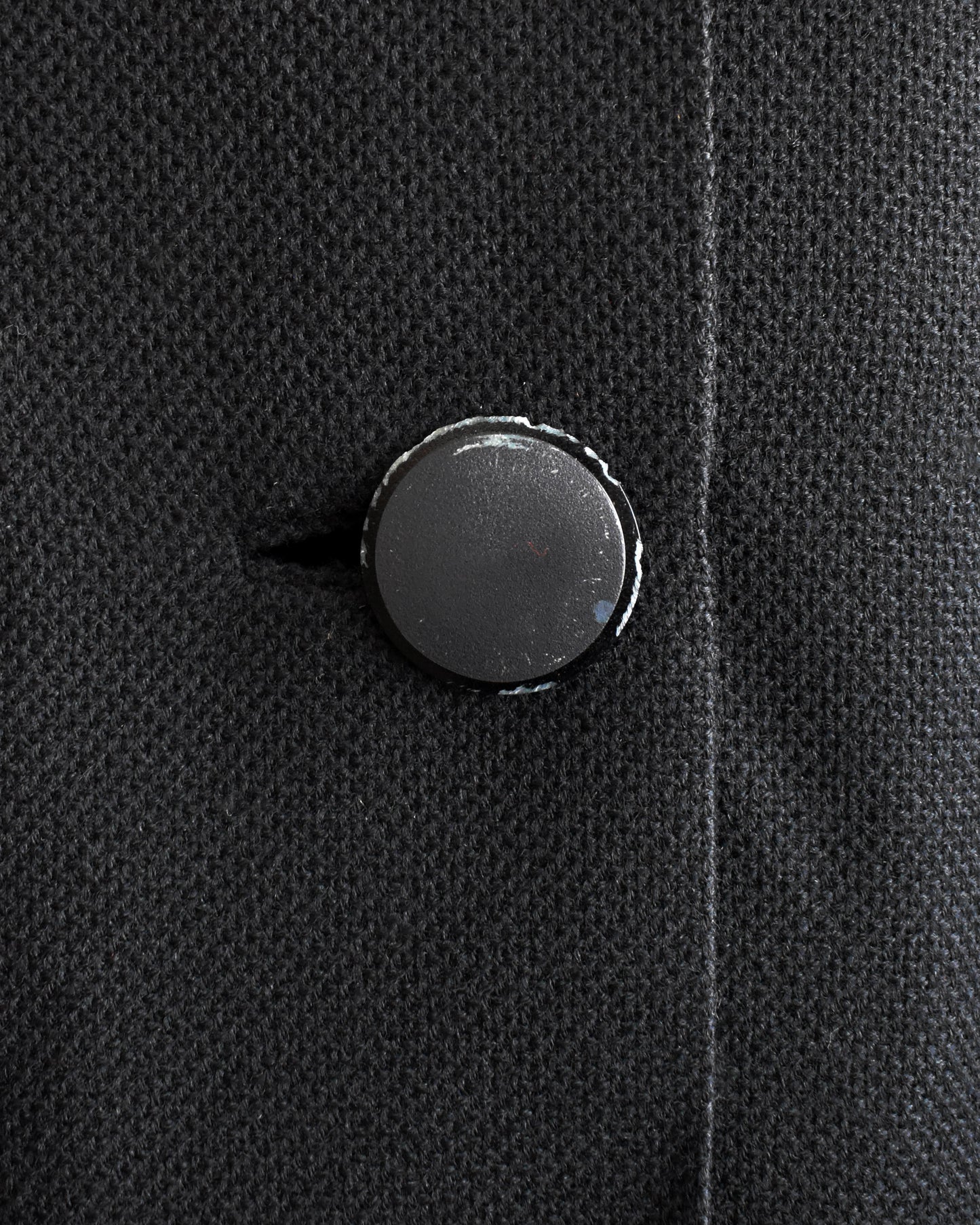 close up of the bottom button which shows some wear on it
