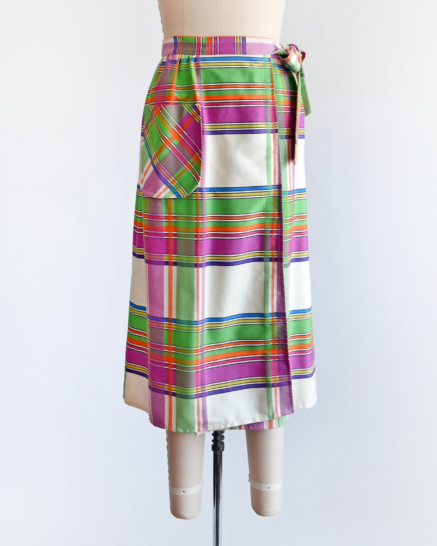 A vintage 60s plaid wrap skirt with a patch pocket on the front.