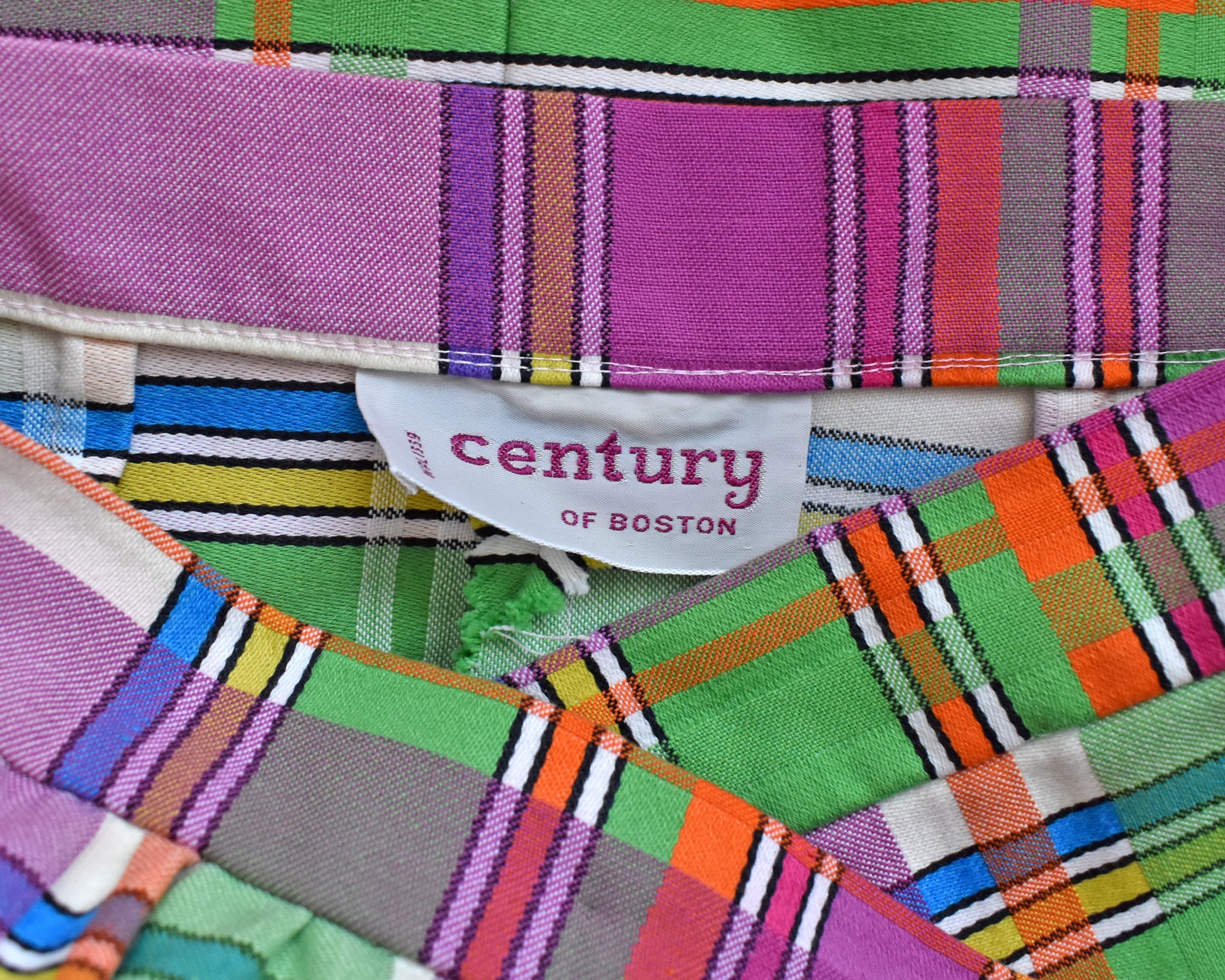 close up of the tag which says century of Boston