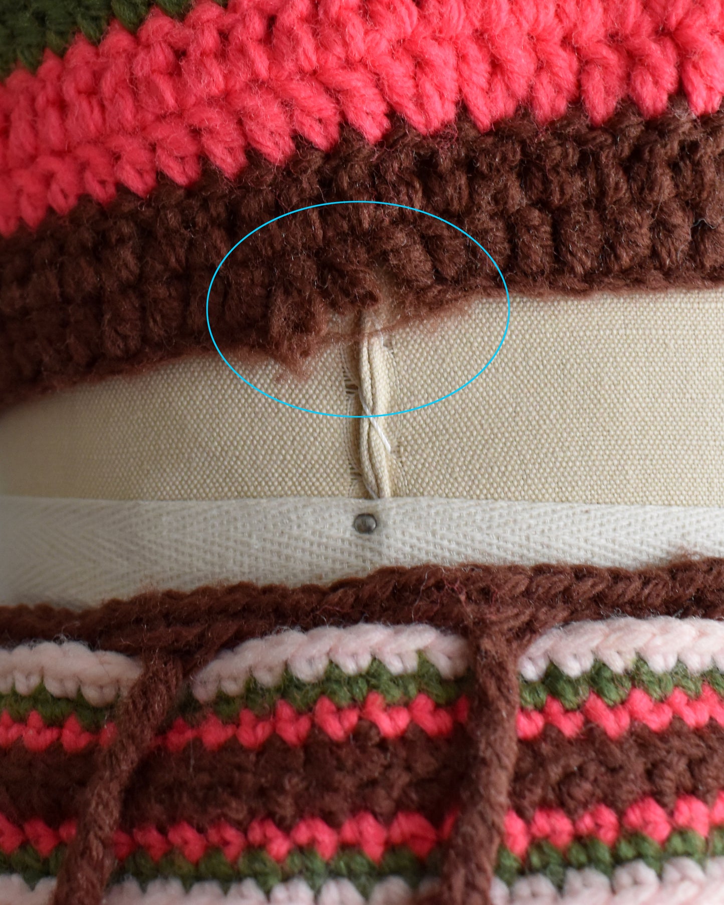 close up of the small break in the crochet on the right side of the hem of the crop top