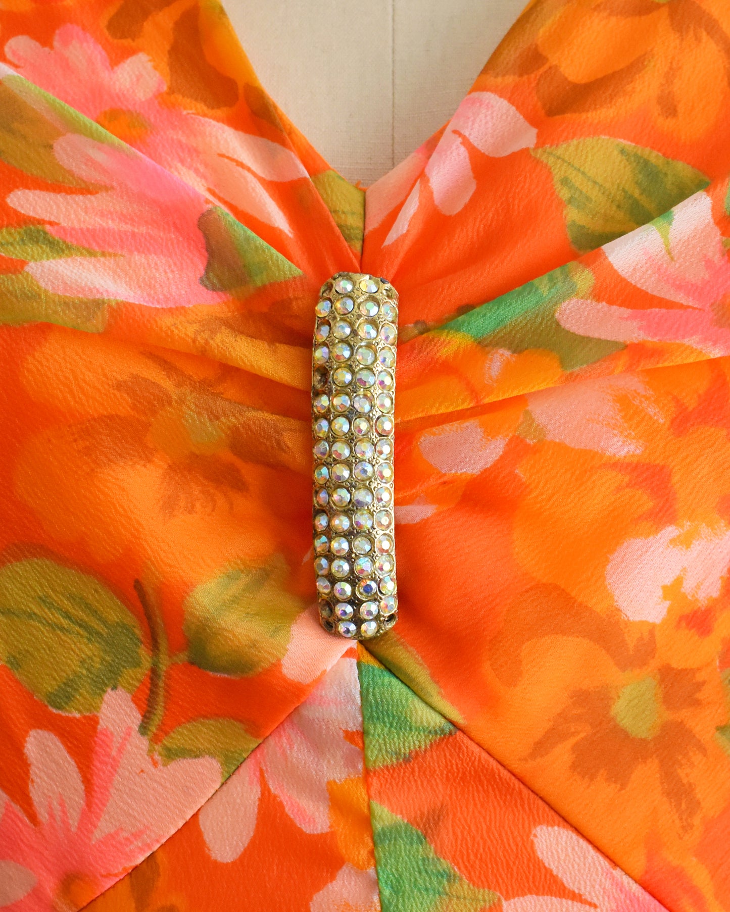close up of the rhinestone brooch which has a few stones missing