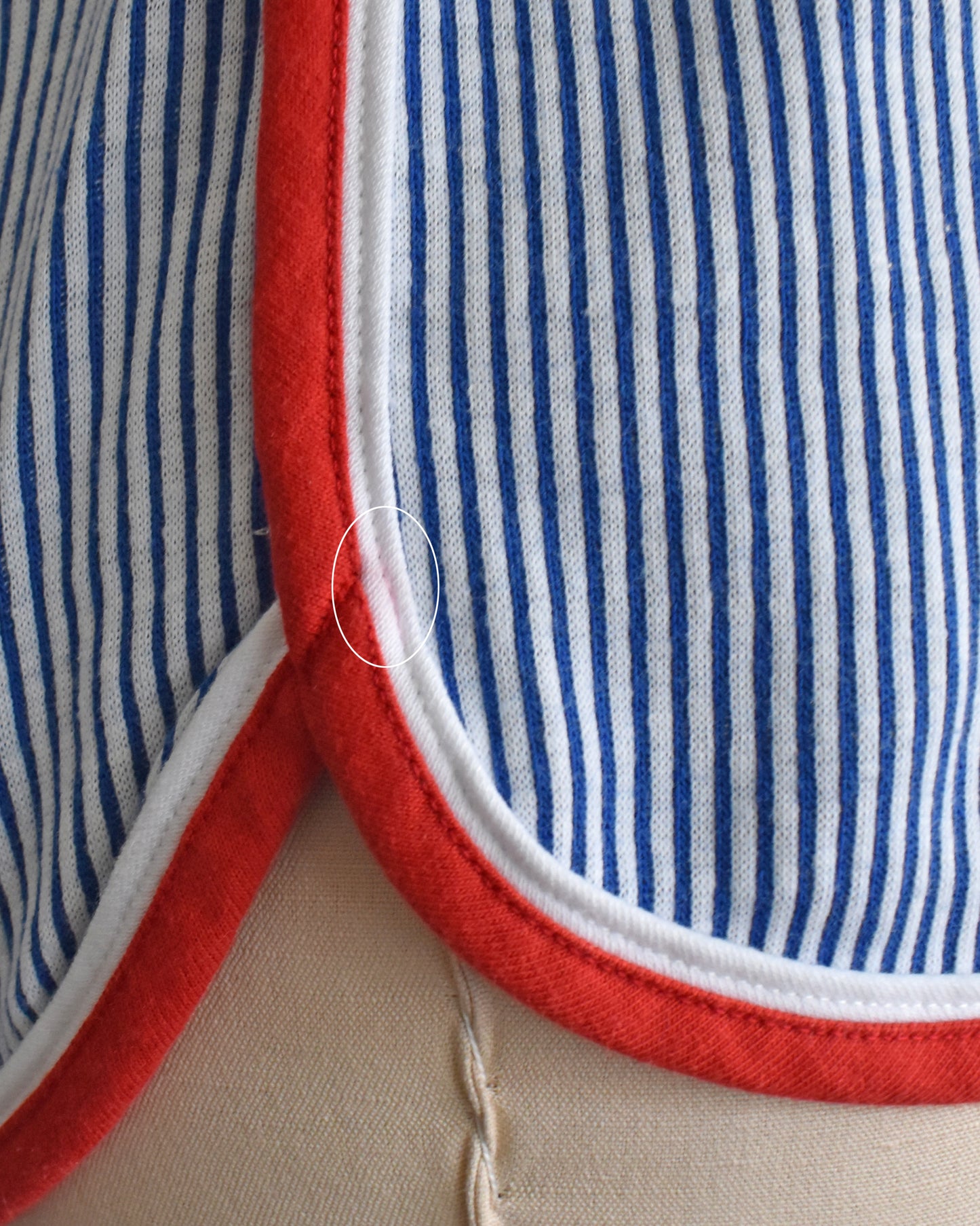 close up of a faint red color bleed spot on the side of the right left